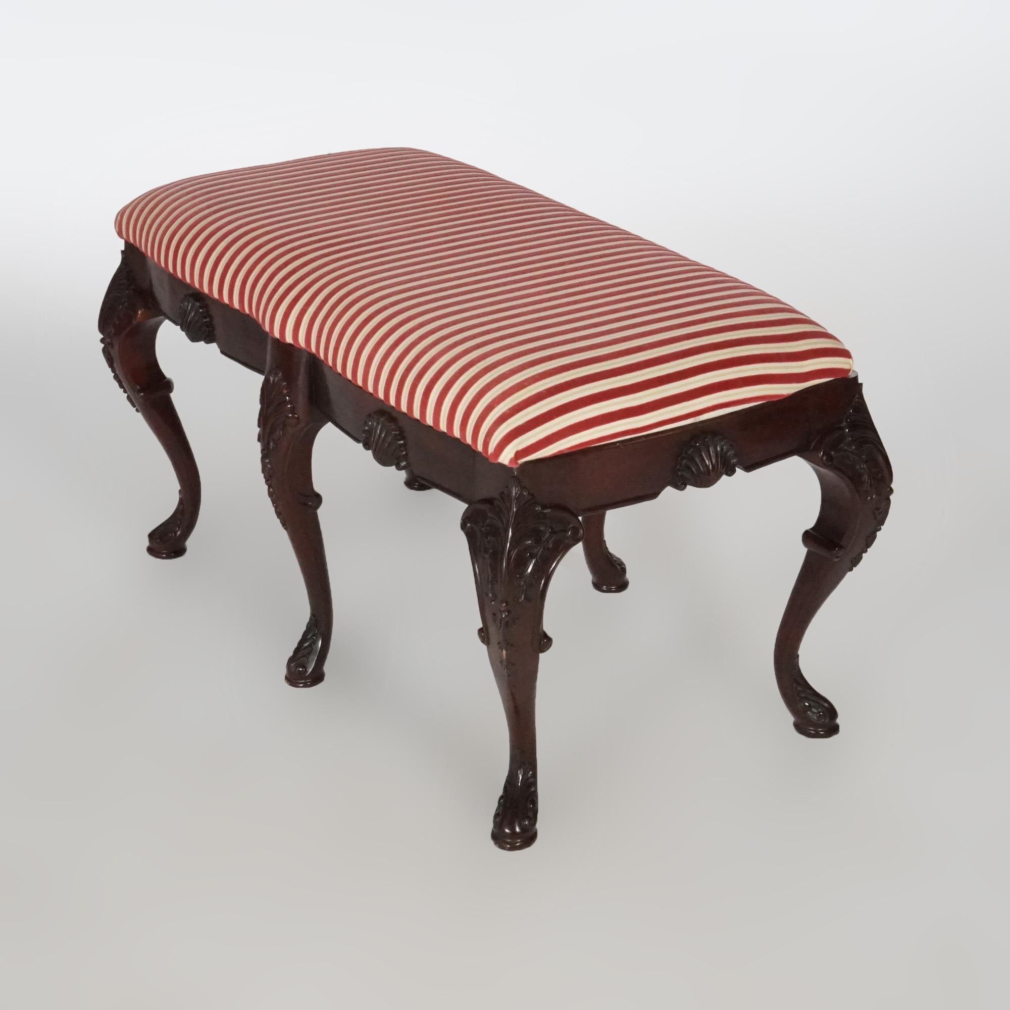 A French style long bench offers upholstered seat over mahogany base with carved shell and foliate decoration, raised on cabriole legs, 20th century

Measures- 19.5''H x 35.5''W x 18.5''D.
