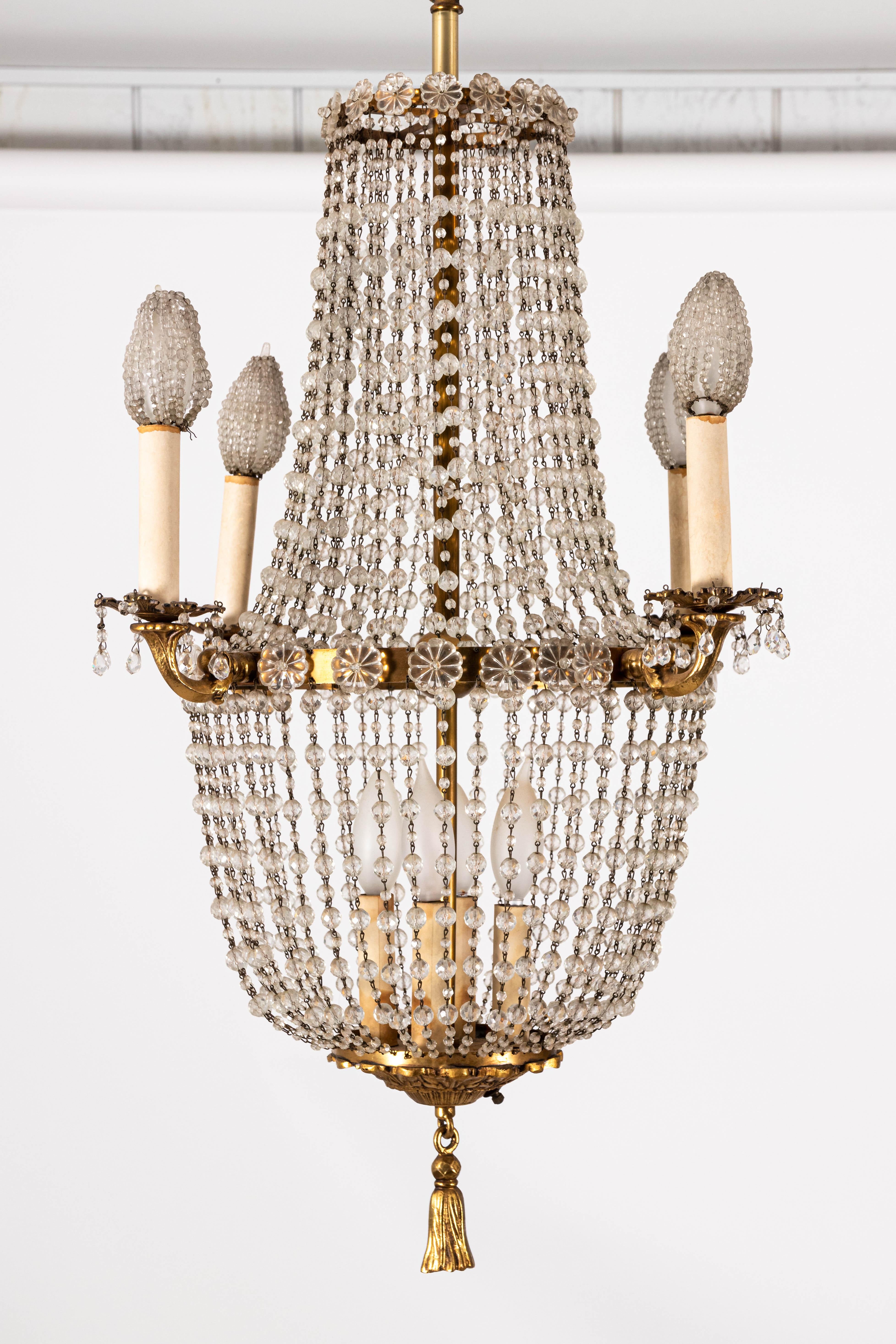 French style crystal beaded brass chandelier with four external arms with beaded bulb covers and three internal lights inside the basket frame.
