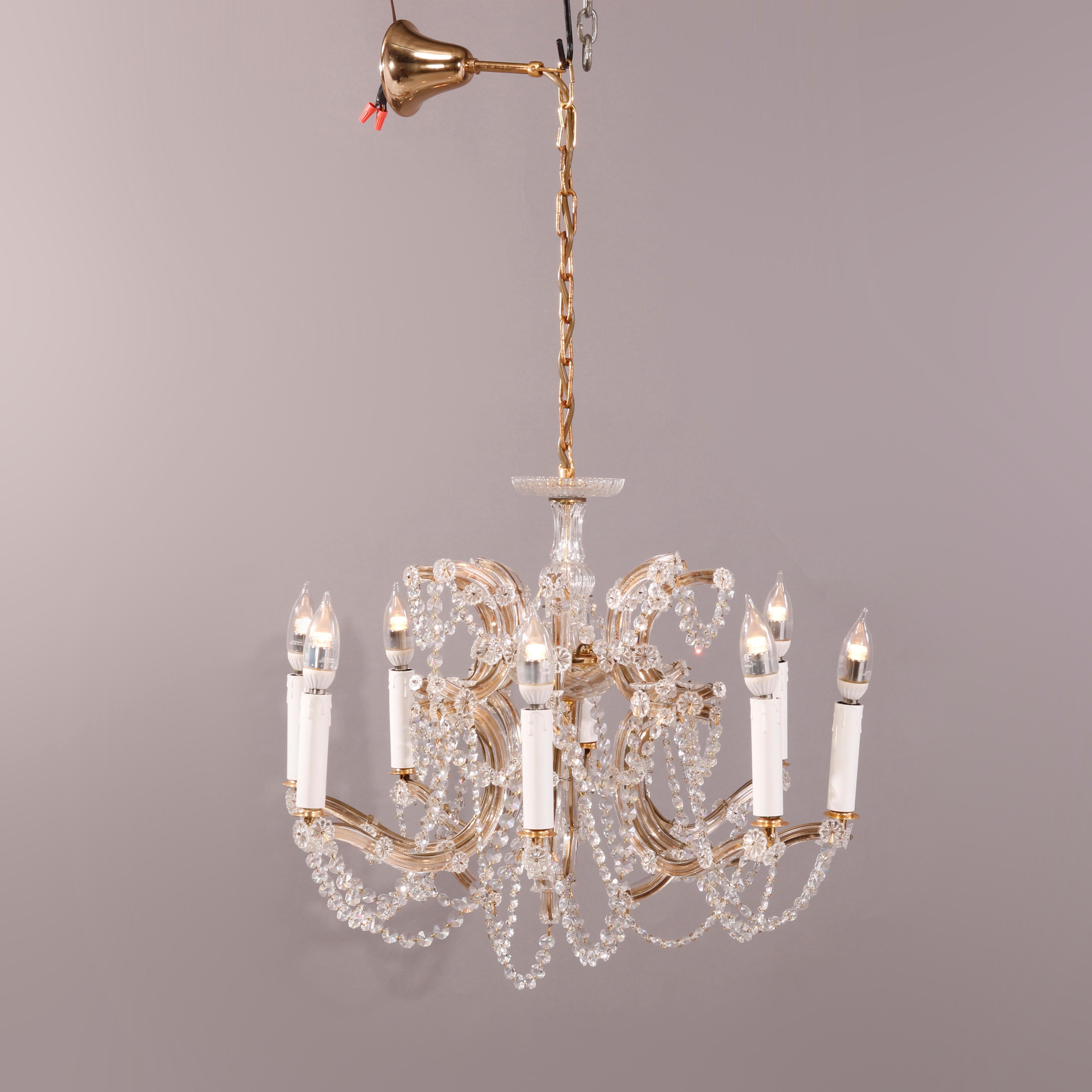 A vintage French style chandelier offers frame with foliate form elements and pierced band having candle lights, drop and strung crystals throughout, 20th century 

Measures- 31''h x 19.5''w x 19.5''d; 6'' drop.

Catalogue Note: Ask about DISCOUNTED