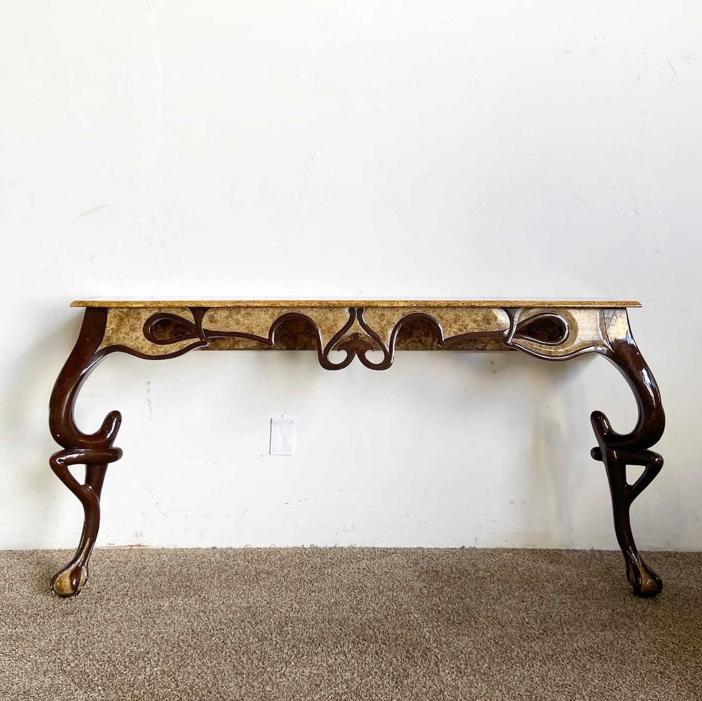 Add elegance to your space with the wonderful vintage French style console table. This table features dark brown finished legs with ornate sculpting and ball-in-claw feet, topped with a faux burl design on the table top and feet, creating a