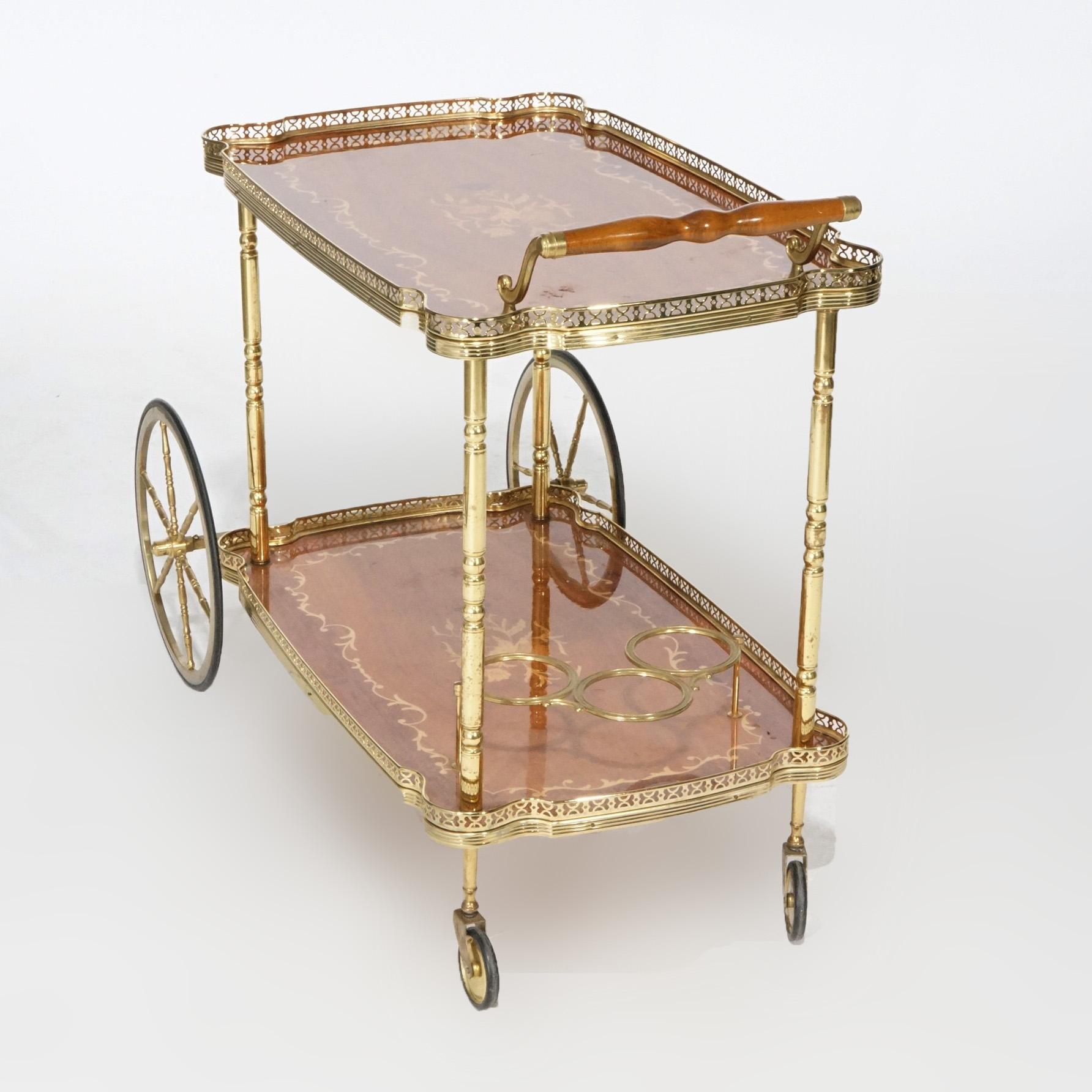 A French style serving cart offers brass frame with mahogany trays having satinwood floral marquetry, 20th Century
Measures- 29.25''H x 37.75''W x 19.75''D