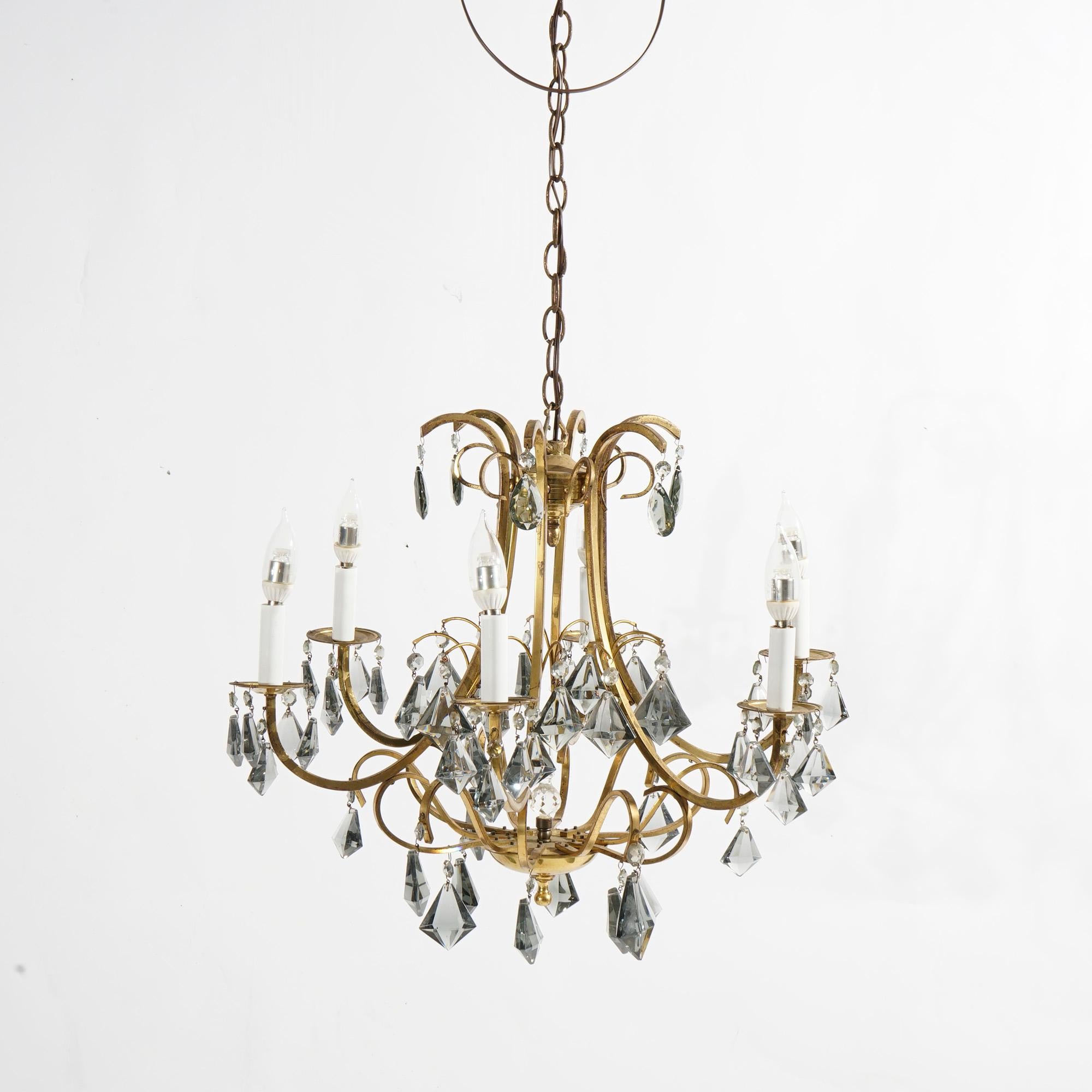An antique French style chandelier offers gilt metal frame with six scroll form arms terminating in candle lights, hanging cut crystals throughout, c1930

Measures- 40.25''H x 23.5''W x 23.5''D.

*Ask about DISCOUNTED DELIVERY rates within 1,500
