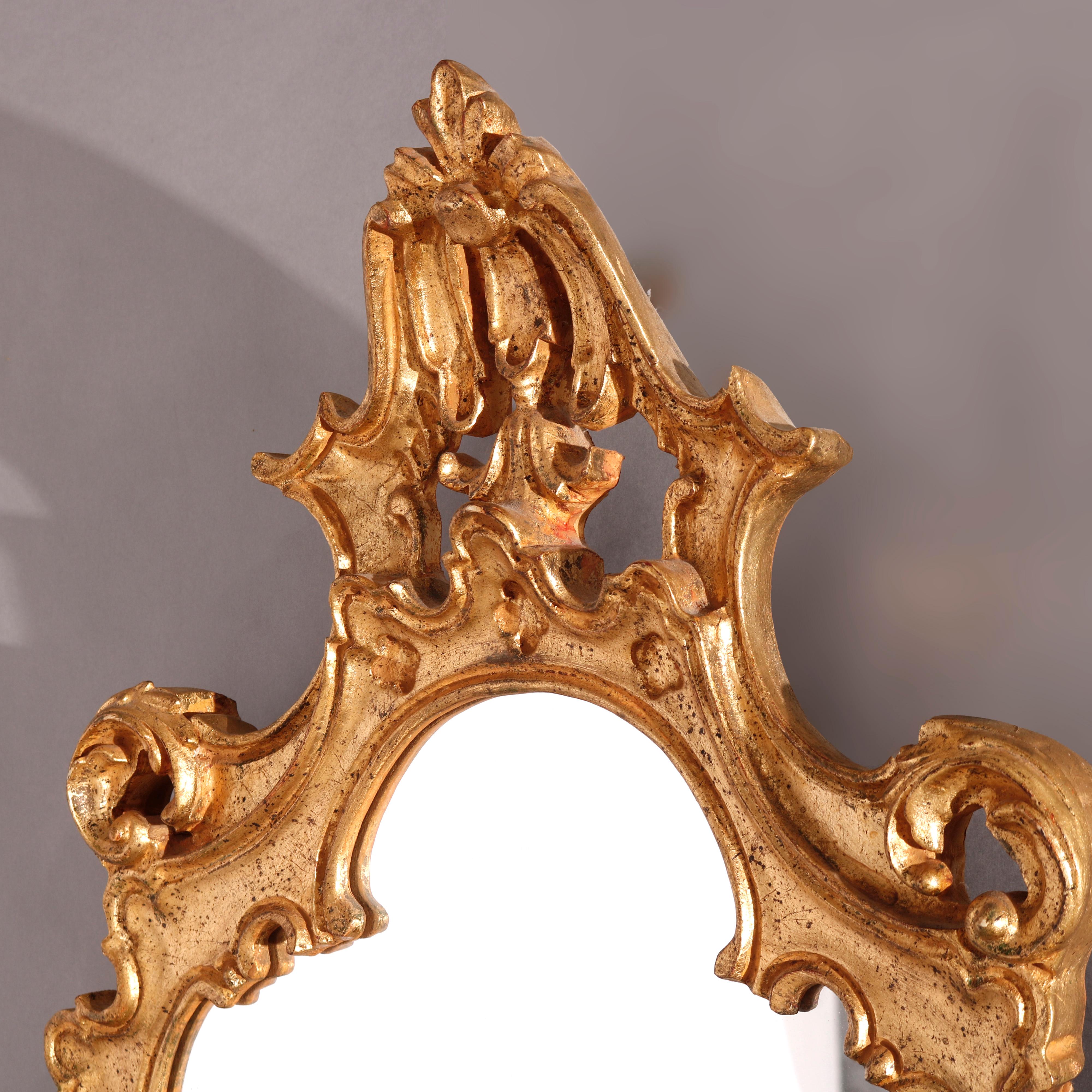 A French style wall mirror offers giltwood frame with pierced cartouche over foliate form frame, 20th century

Measures - 40