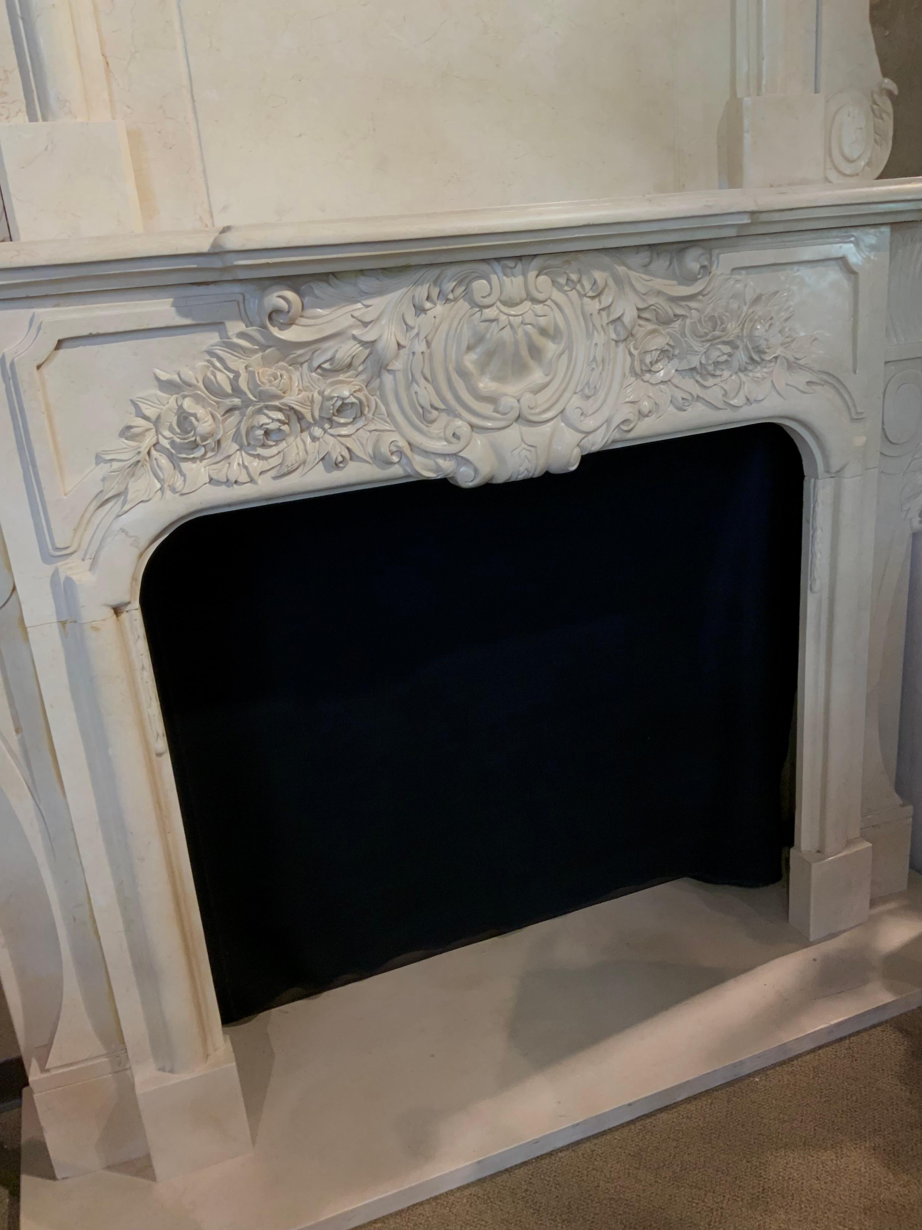 This mantel is considered a double mantel because it has
An upper structure that makes it very tall and elegant.
The carving is very good and has a cartouche at the top
And also has a central carved cartouche at the center of
This mantel. The