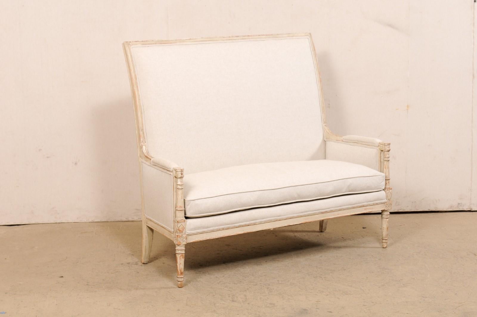 A French style high-back settee designed by US Furniture maker Yale R. Burge. This vintage settee has been finely crafted with French design influences and features a beautiful high-back, upholstered and framed within straight molded wood lines, and
