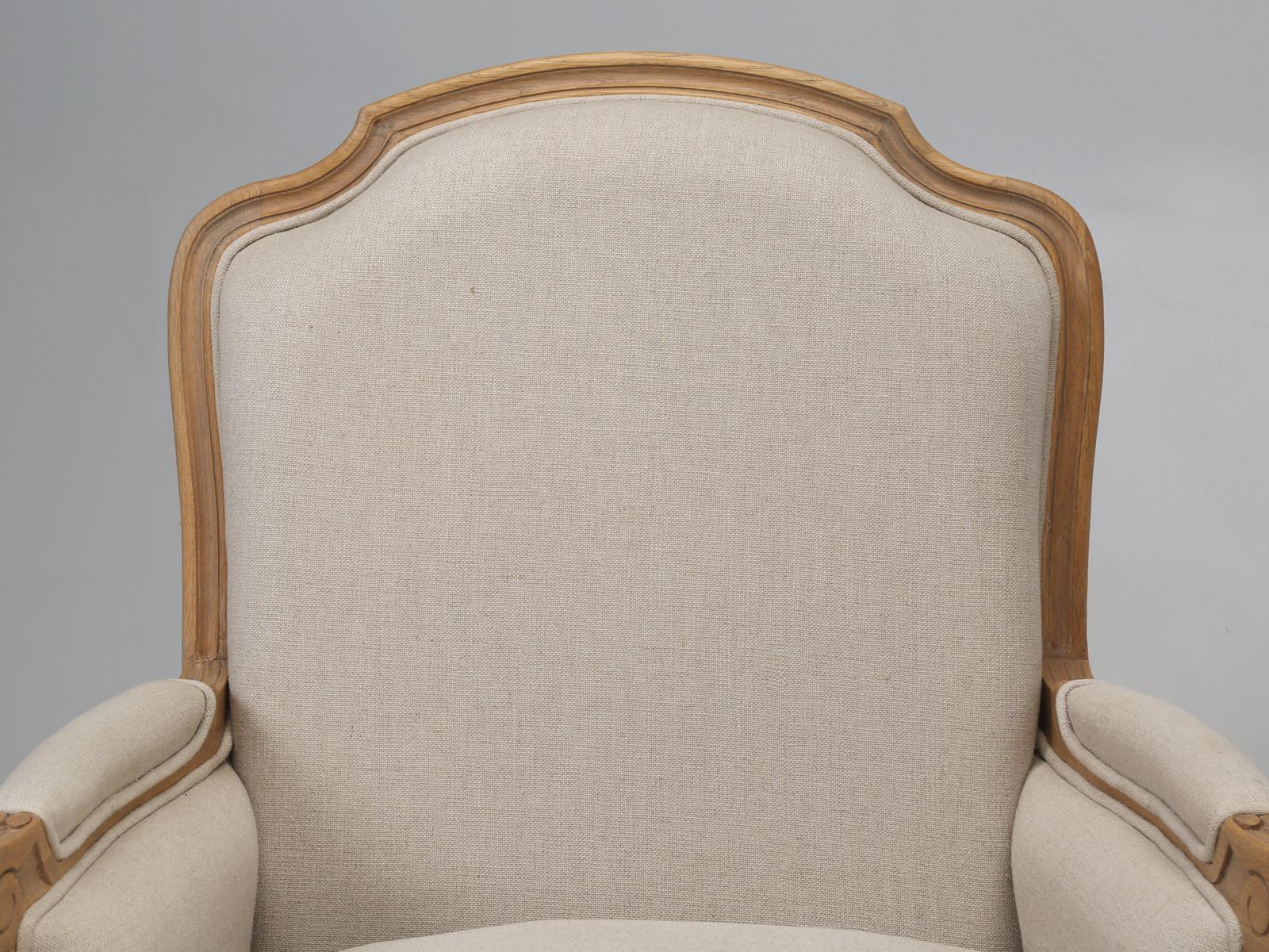 Pair of French style bergère chairs, that are defined as an enclosed upholstered armchair and are fully upholstered. Most bergère chairs are fitted with a loose, tailored seat cushion, that was designed for the utmost in comfort and relaxation. The
