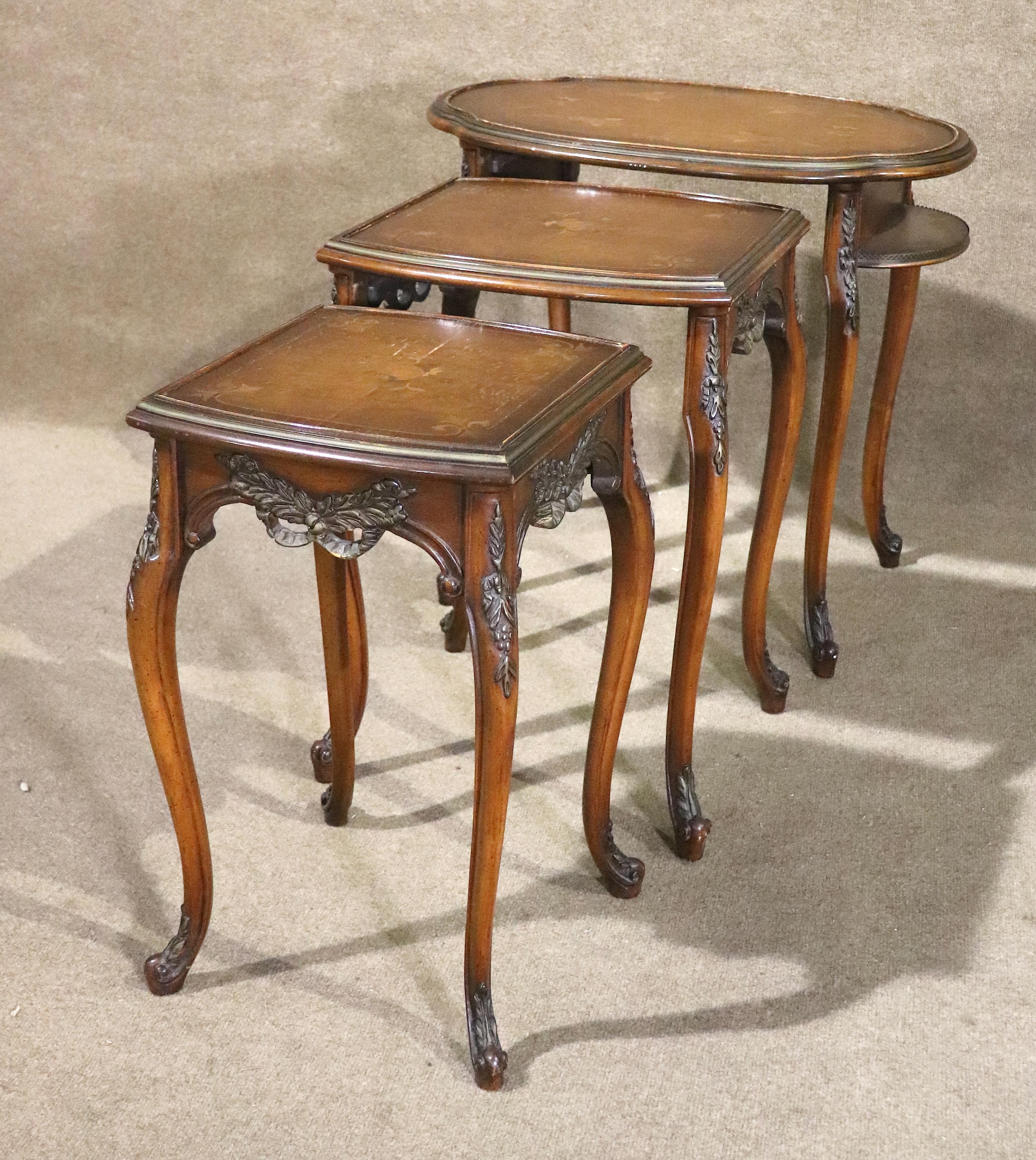This set of French style stacking tables feature marquetry tops and carved embellishments. Three tables that nest inside each other are perfect for hosting.
Please confirm location NY or NJ