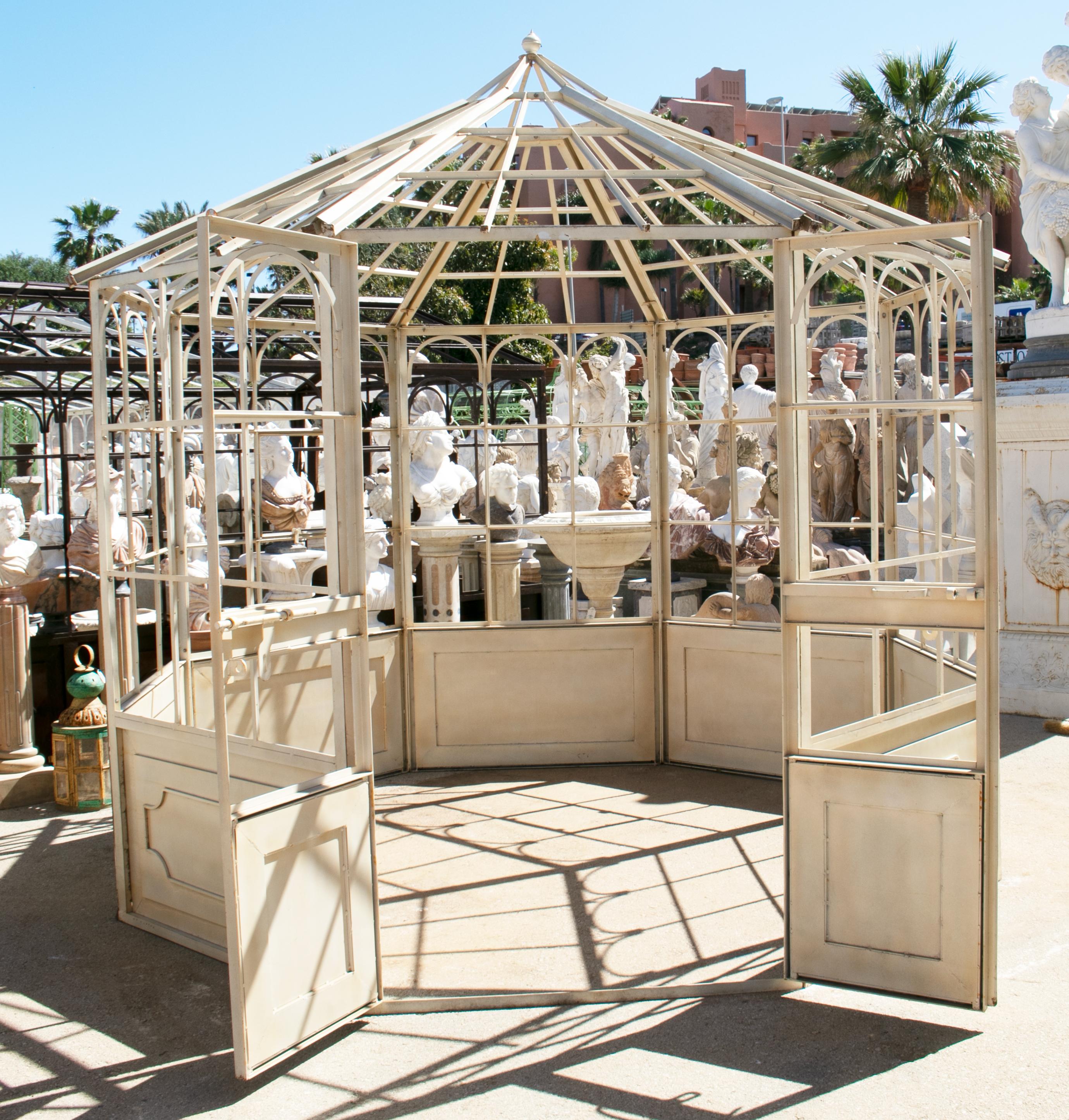 French style octagonal iron greenhouse with door and windows.