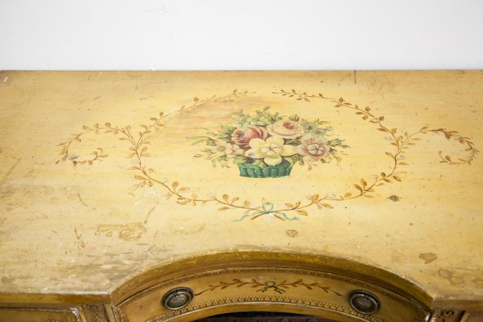 French style painted one drawer console table has a top painted with garlands and baskets of flowers. Leaf swags are carved into the stiles of the fluted legs. Paint has been touched up and restored.