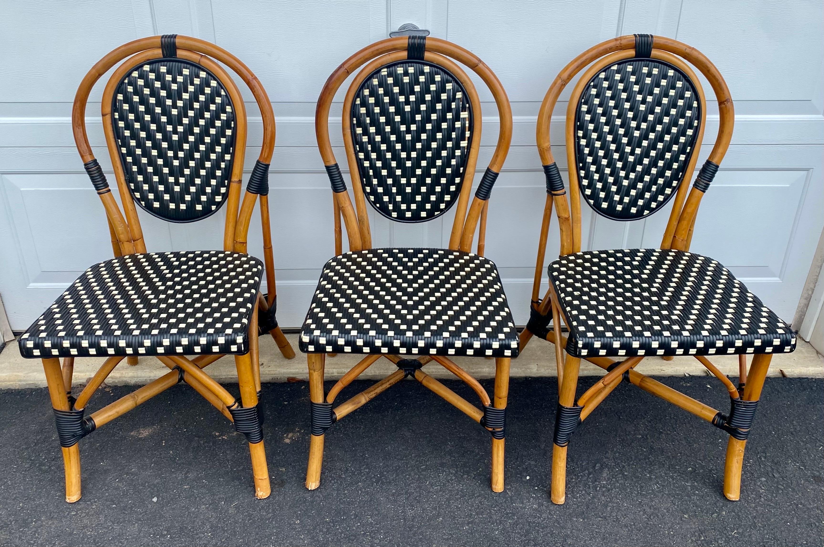 Set of 6 classic French style bistro dining side chairs just like those you find in a Paris café. Frames expertly hand crafted of natural Malacca/Manau steamed bent cane with durable woven synthetic nylon wicker seats and backs in neutral