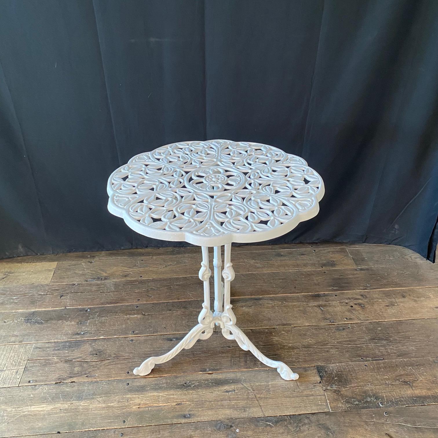 A great addition to your outdoor patio or garden, this lovely British sturdy, durable metal cast aluminum outdoor cafe, bistro or dining table provides ornate styling. Lovely sunflowers and tulips interwoven with vines in table top design. Three