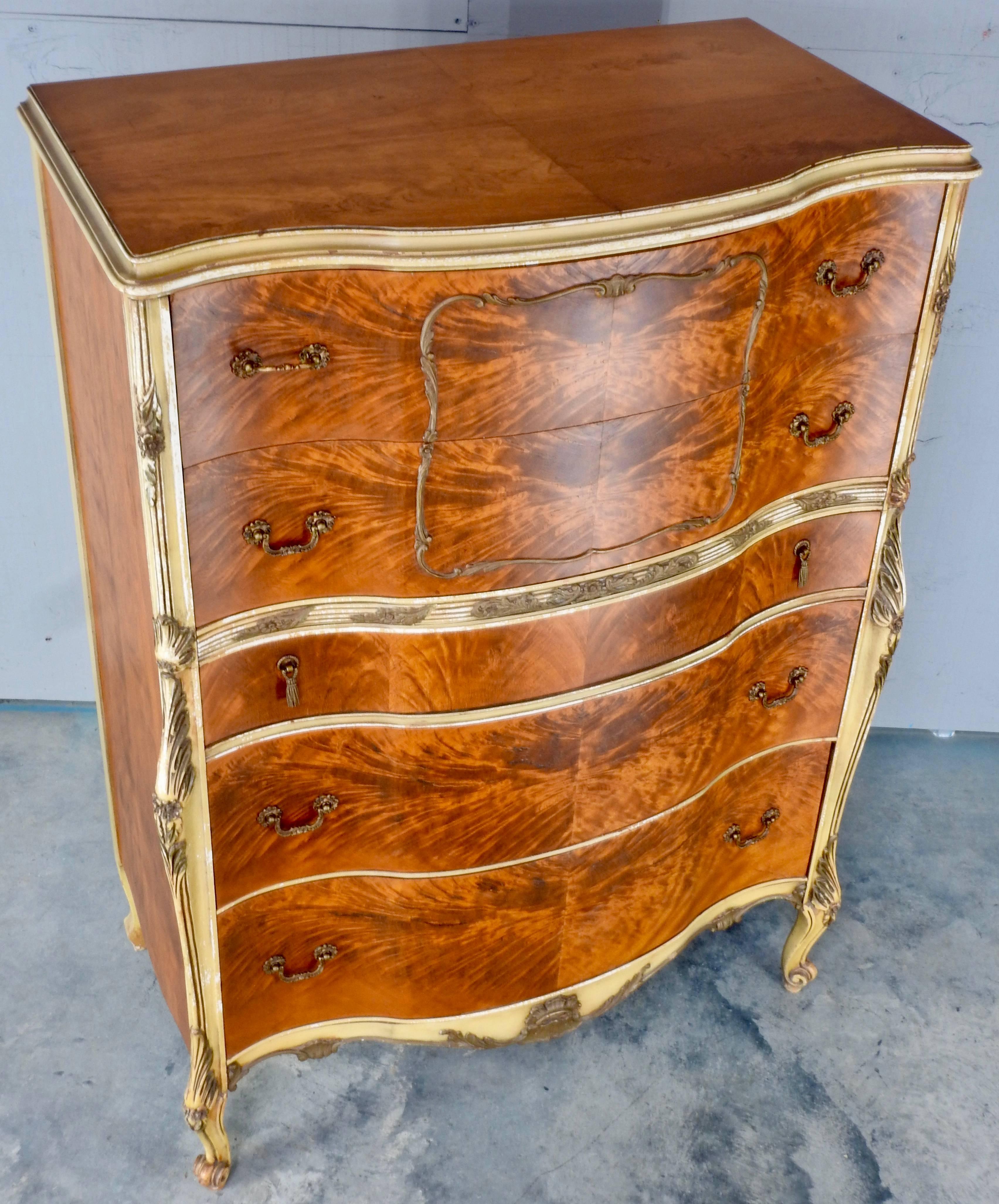 Elegant satinwood makes up this ornate chest on chest from France in the early 20th century. Wood trim painted gold adds to the beauty of this piece. Five drawers give you ample storage. The curved front adds to the grace of this chest. This piece