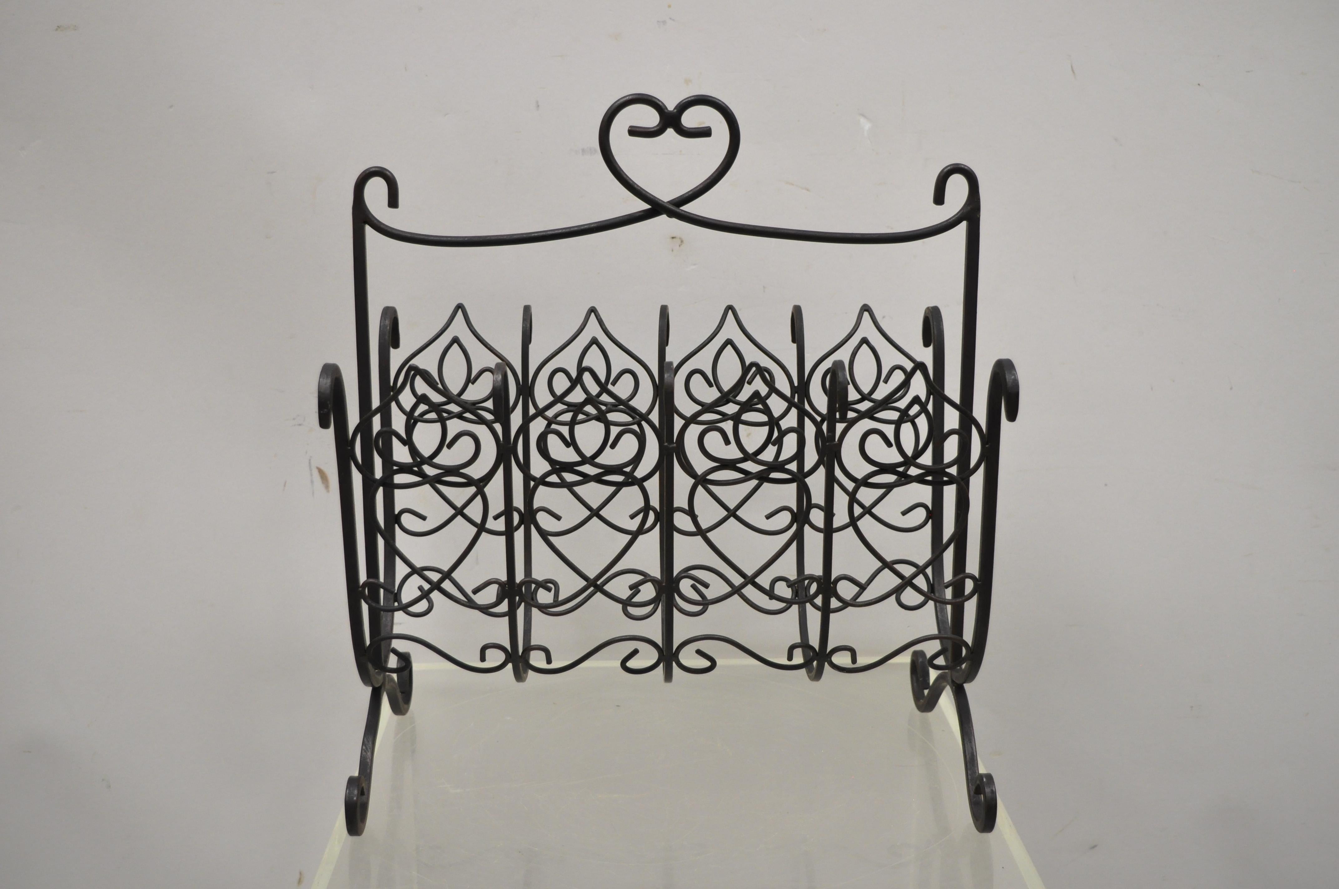 French style scrolling wrought iron magazine rack stand with heart. Item features a scrolling wrought iron frame, heart design, great style and form. Circa late 20th century. Measurements: 16.75