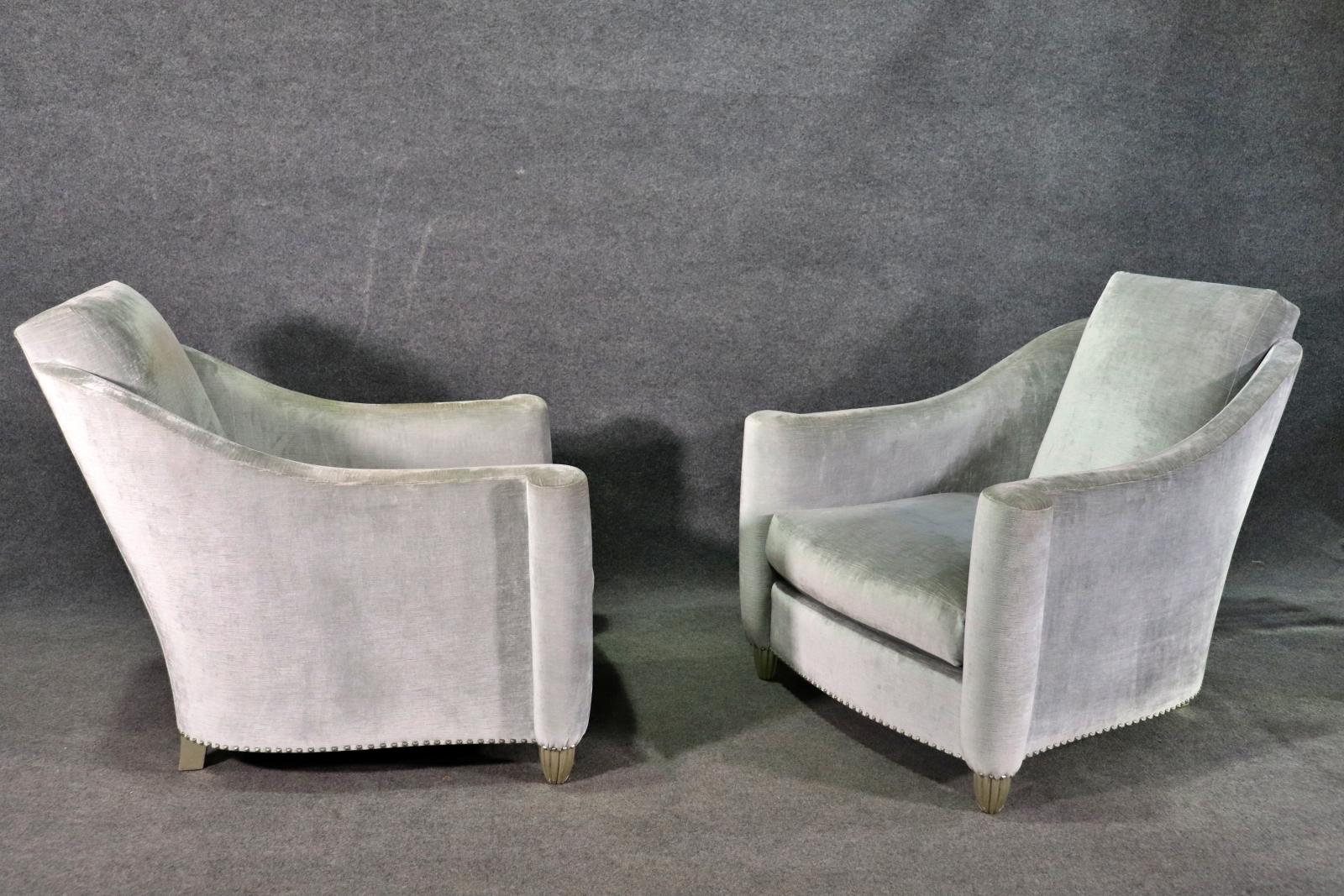 Pair of lovely deco style arm chairs in grey velvet. Long sloping back with scrolled arms and nail head trim around the base.
Please confirm location NY or NJ