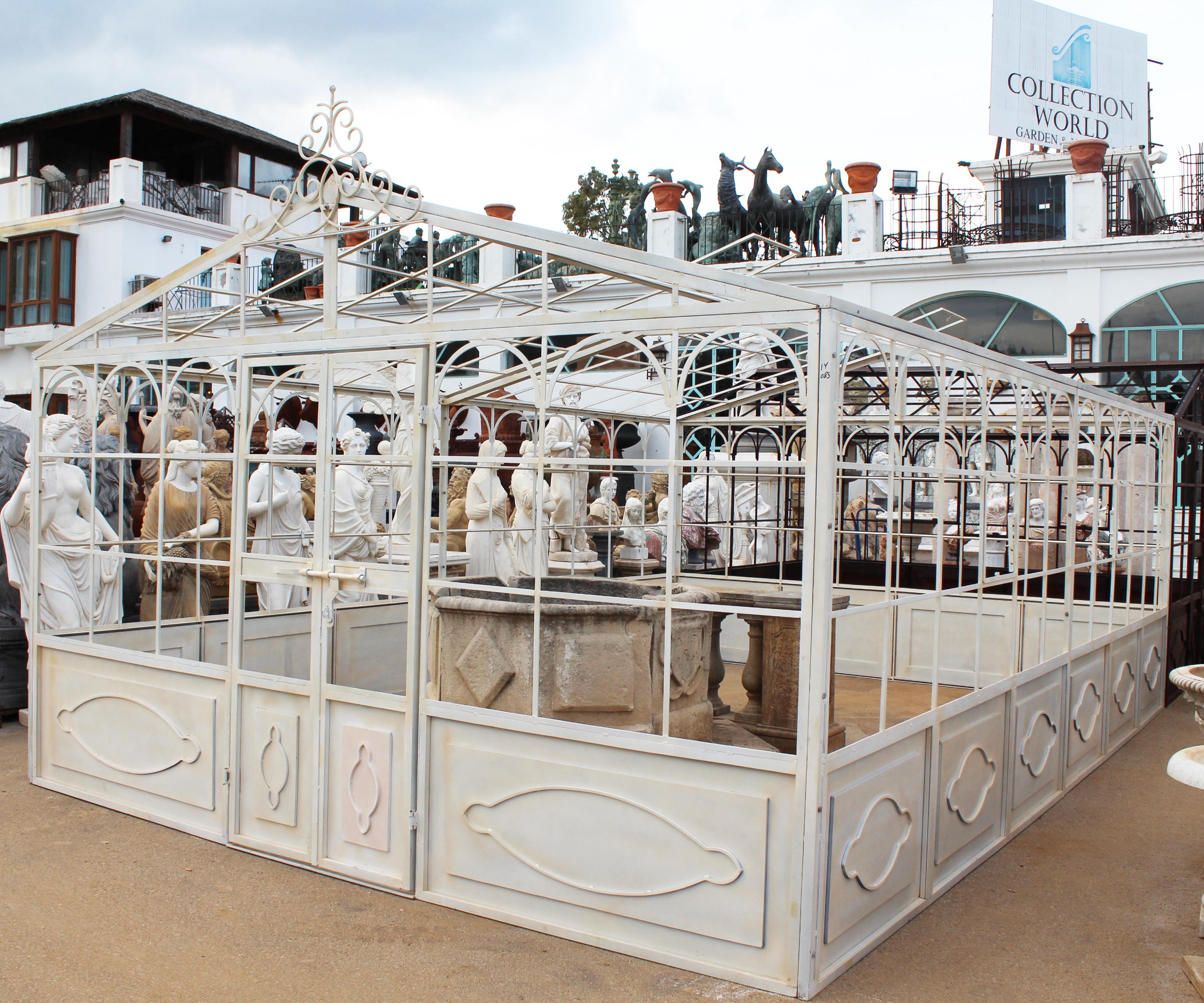 French style wrought iron greenhouse with doors and windows that open outwards in white color. Ready for glass panels to be installed.