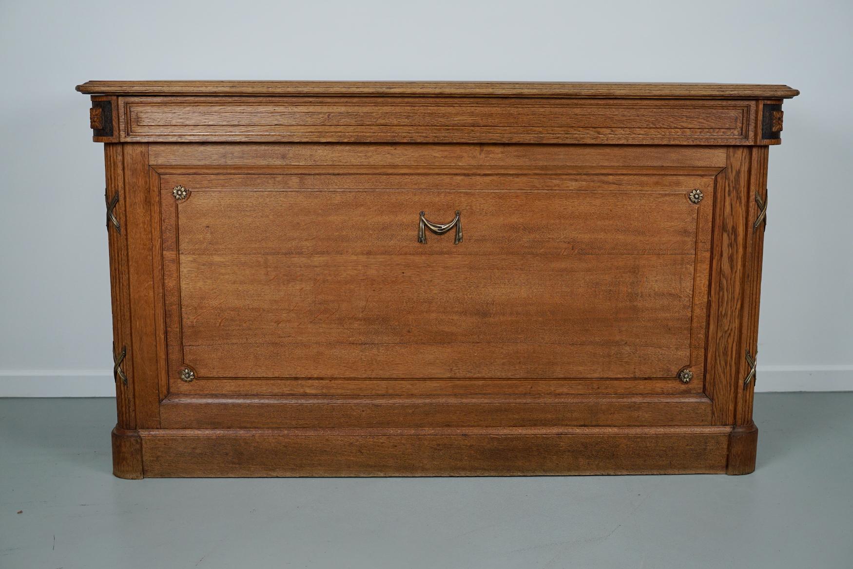 This rare shop counter was made in the Napoleon 3 period in France from gold oak. It has amazing bronze hardware and two drawers with a shelve at the back. It could be placed against a wall or used as a shop counter / desk. The interior dimensions