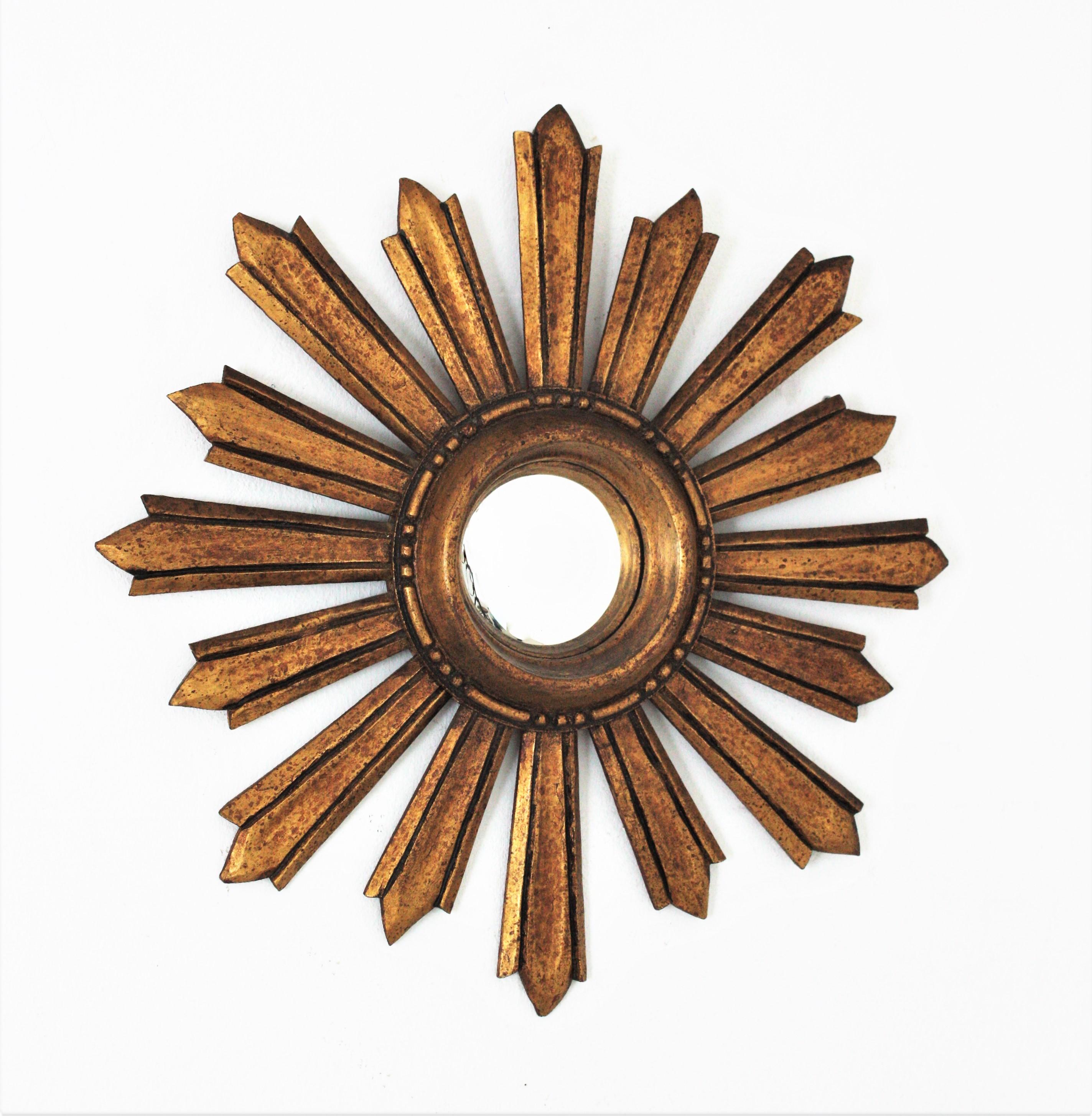 Sunburst convex mirror, giltwood, gold leaf, France, 1940s.
Gorgeous gold leaf gilt carved wood sunburst mirror with convex glass. It has a terrific patina showing its original gold leaf gilding.
Beautiful placed alone or as a part of a wall
