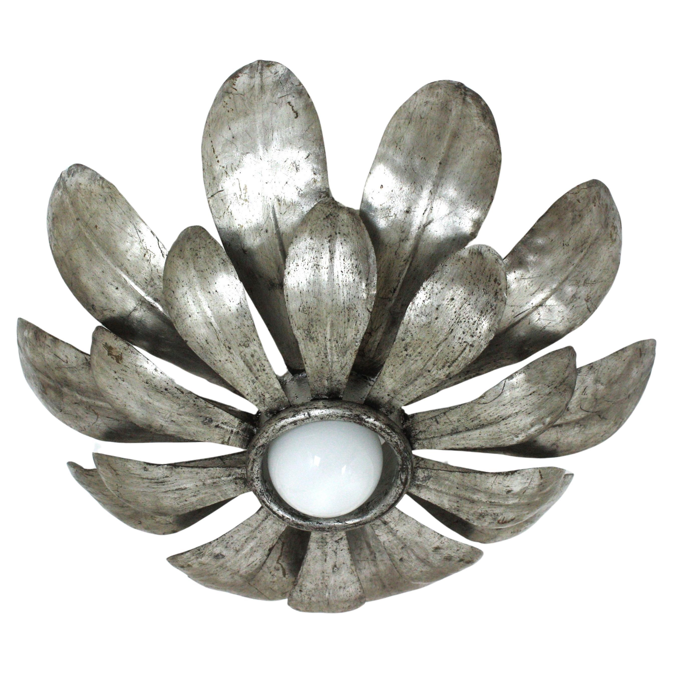 French Flower Sunburst Silvered Metal Flush Mount
One of a kind Hollywood Regency double layered sunburst floral flushmount or light fixture, France, 1950
Rare find.
Produced at the Mid-Century Modern Period in the style of Hollywood Regency.
This