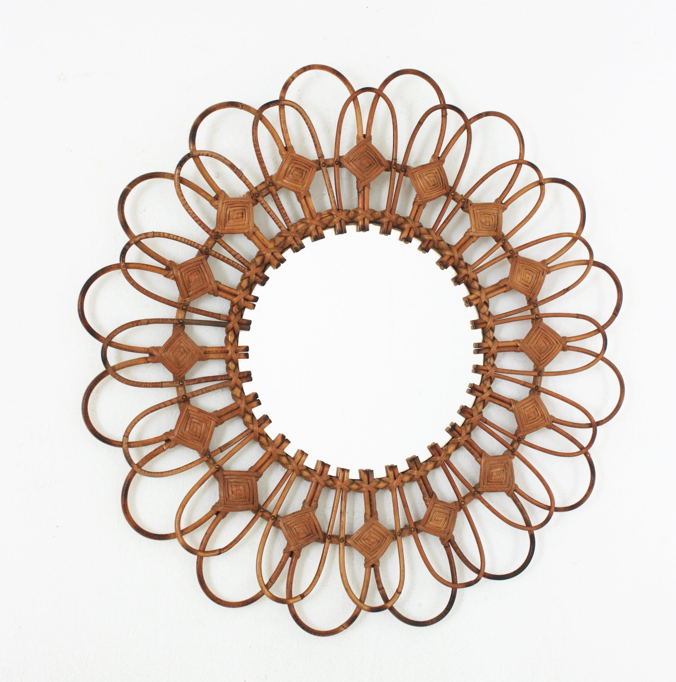 French Riviera Flower Sunburst Mirror in Rattan, circa 1960s
Handcrafted sunburst / flower mirror with rattan and wicker frame, France, 1960s.
This eye-catching Mediterranean sunburst mirror was handcrafted in France at the sixties and it has all