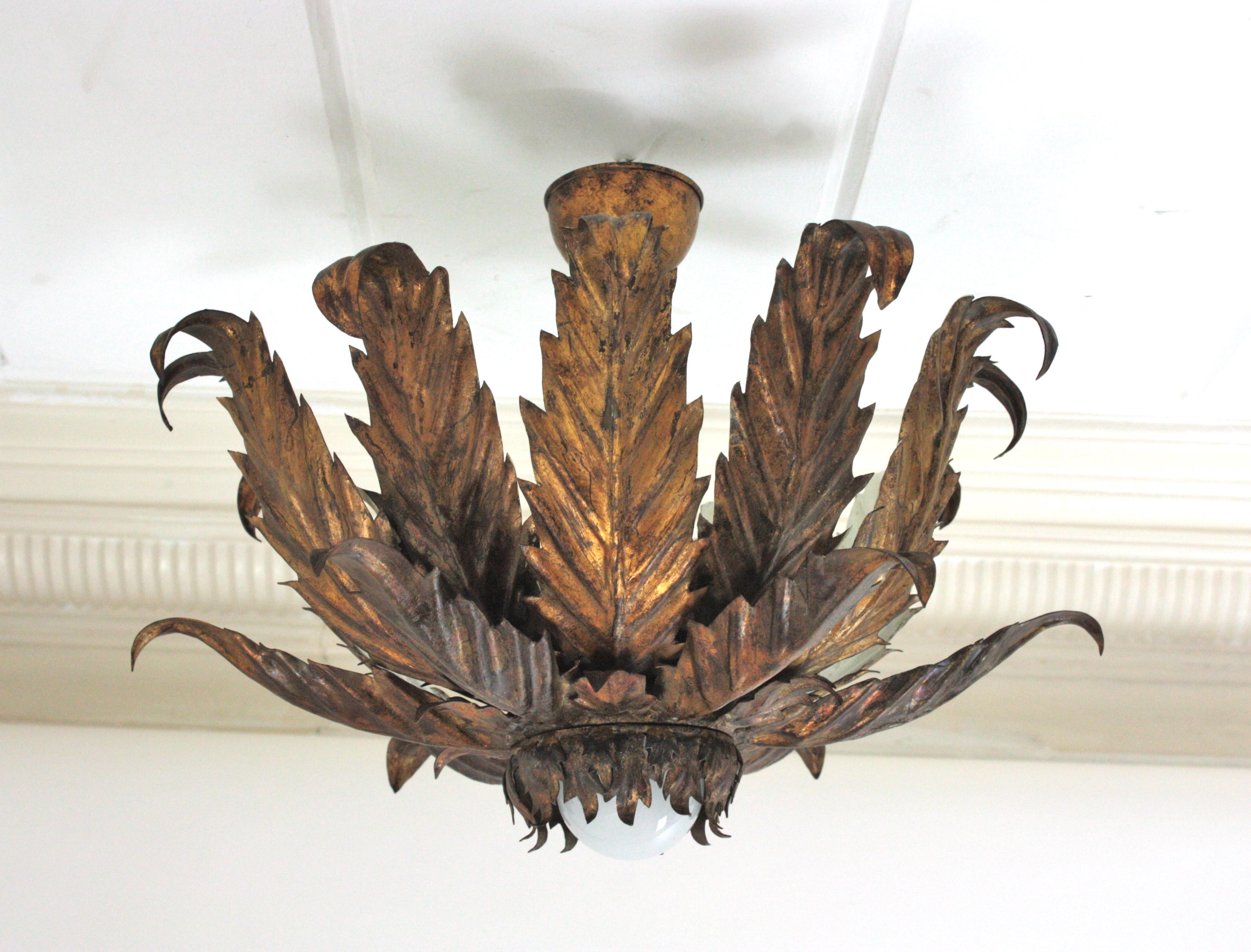 One of a kind French Triple Layered Foliage Pendant Ceiling Light, Gilt Iron
Large size.
Stunning flower leafed sunburst ceiling light fixture, gilt iron, gold leaf, France, 1940s-1950s.
This eye-catching ceiling lamp features a triple layered