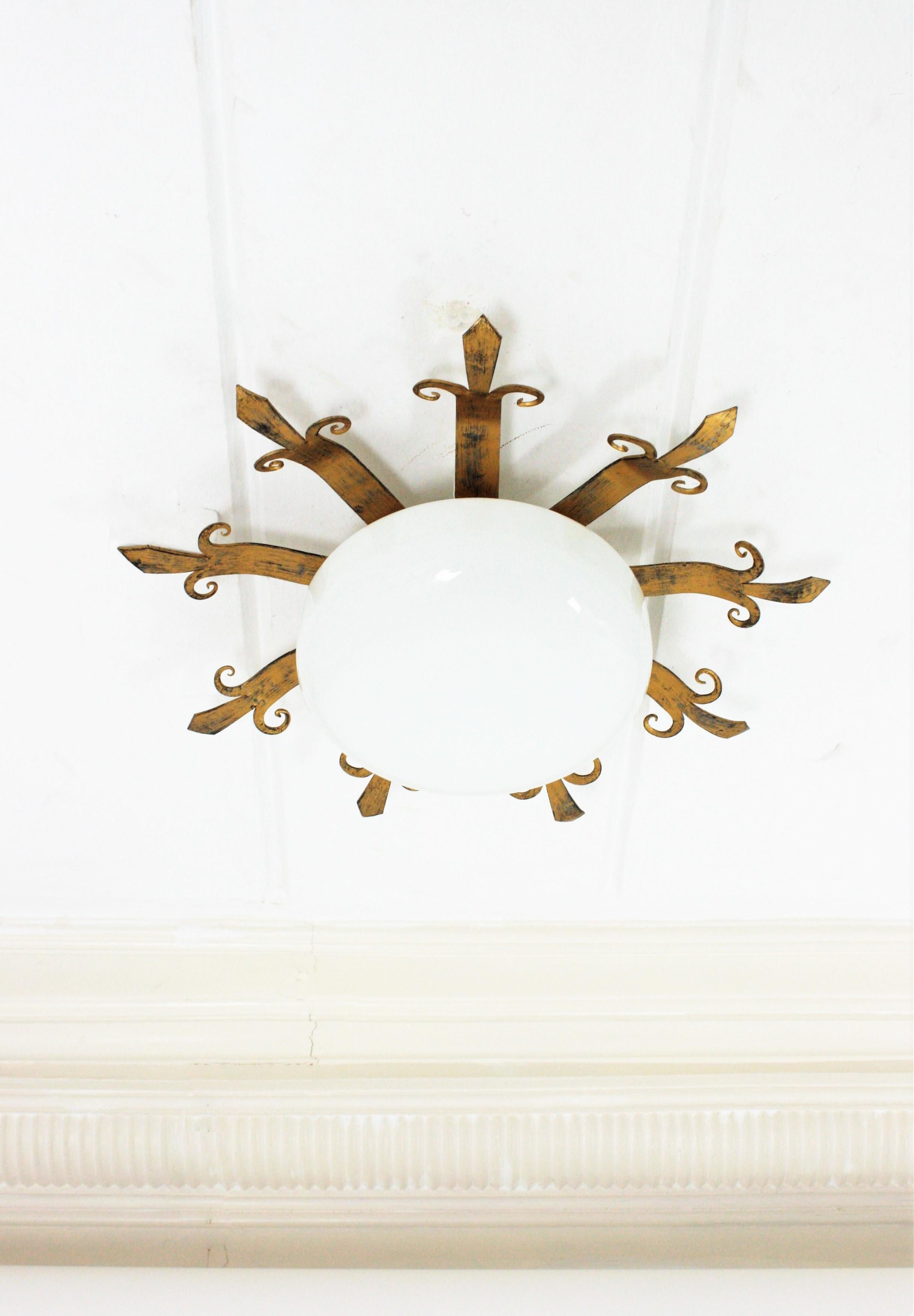 Patinated French Sunburst Light Fixture, Gilt lron and Milk Glass For Sale