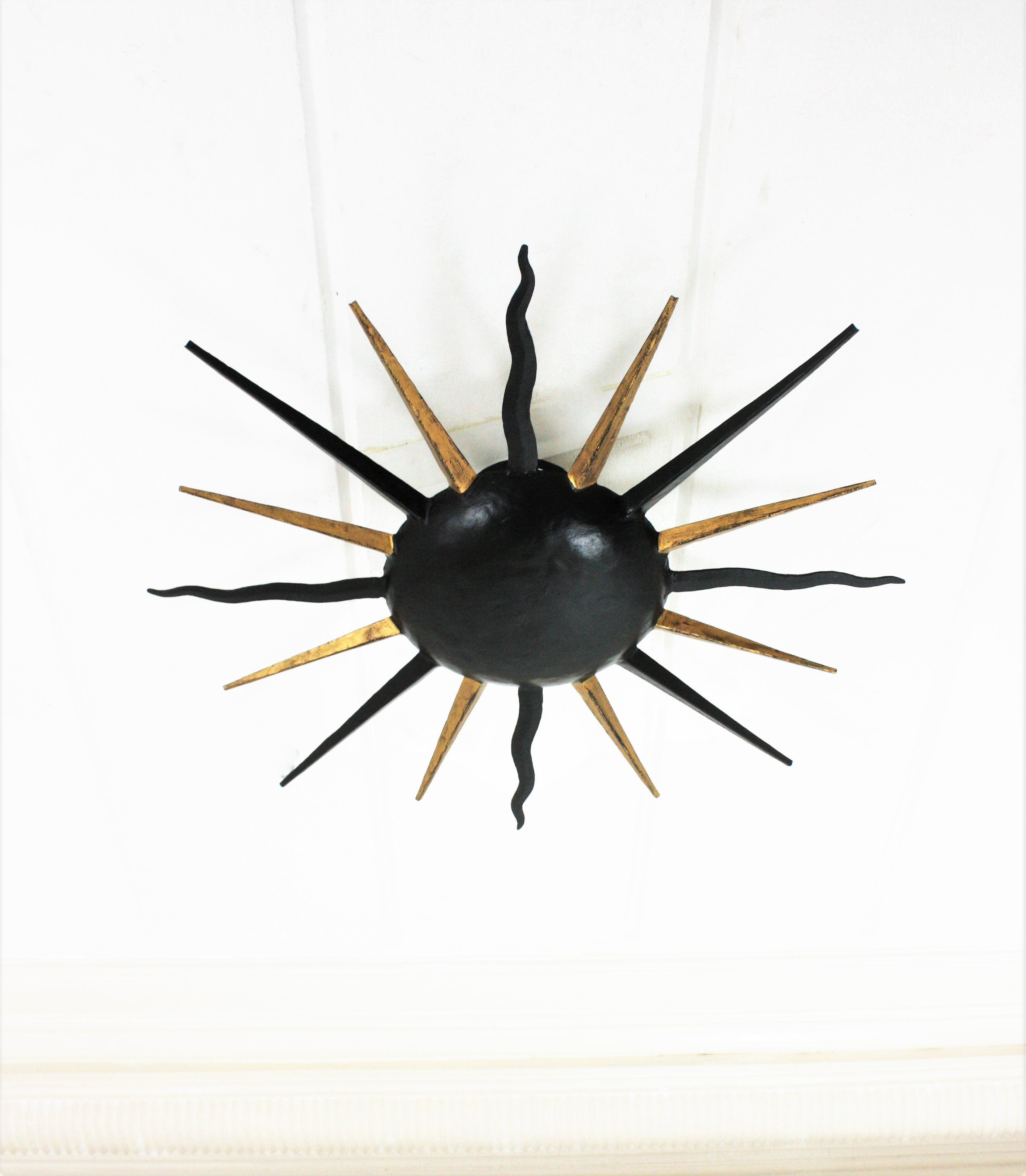 Forged French Sunburst Light Fixture in Black and Gilt Iron, Gilbert Poillerat Style For Sale