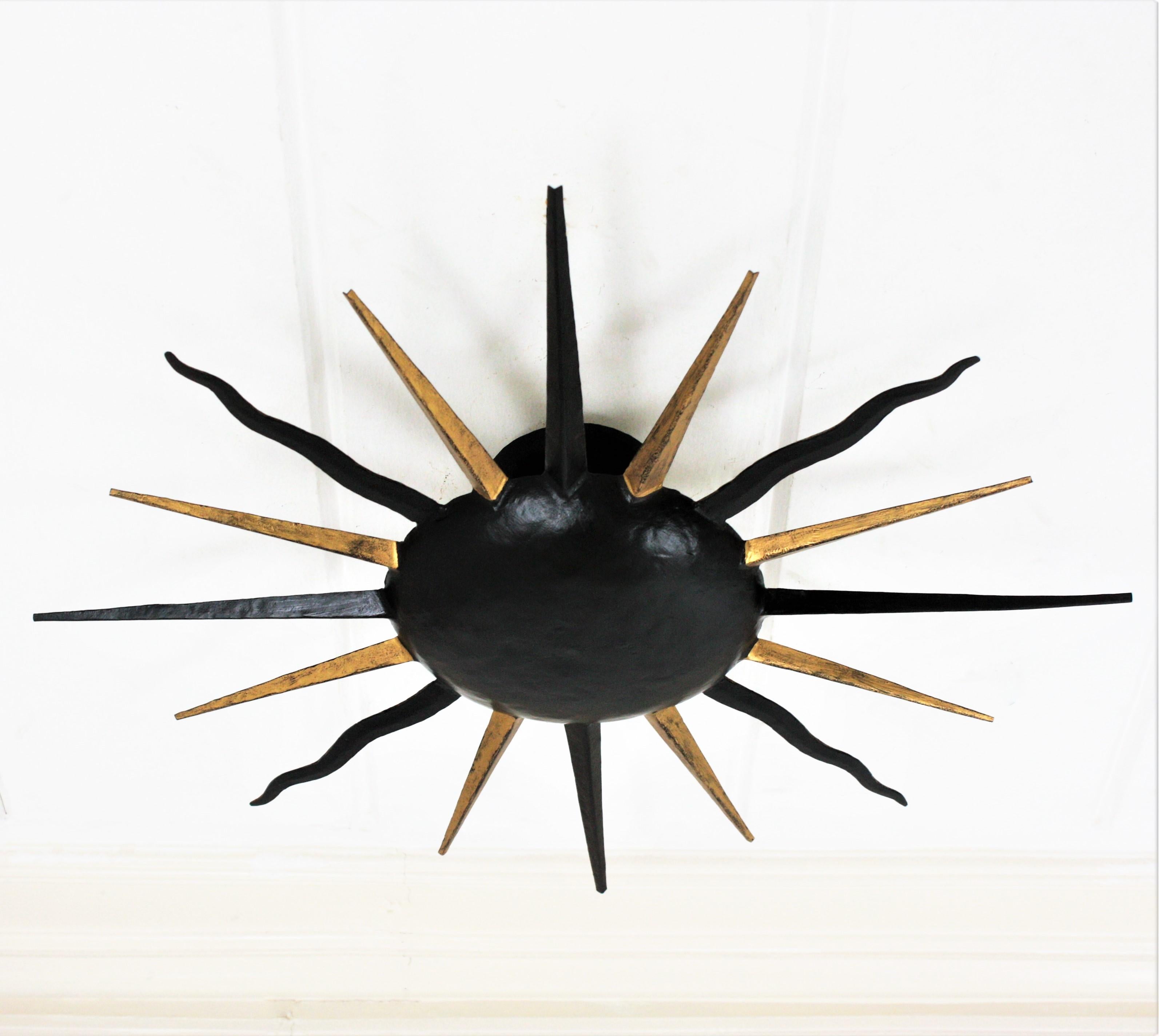 French Sunburst Light Fixture in Black and Gilt Iron, Gilbert Poillerat Style In Good Condition For Sale In Barcelona, ES
