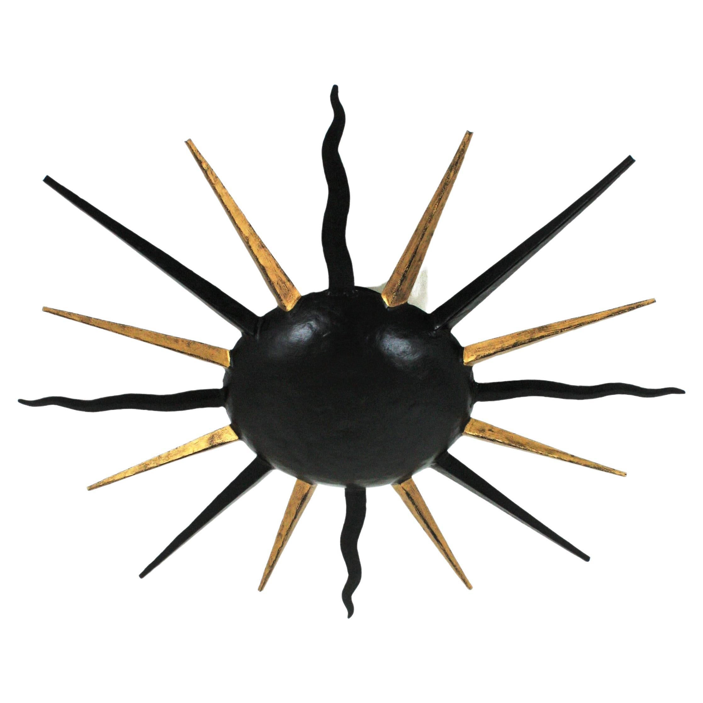 Art Deco French Sunburst Light Fixture in Black and Gilt Iron, Gilbert Poillerat Style For Sale