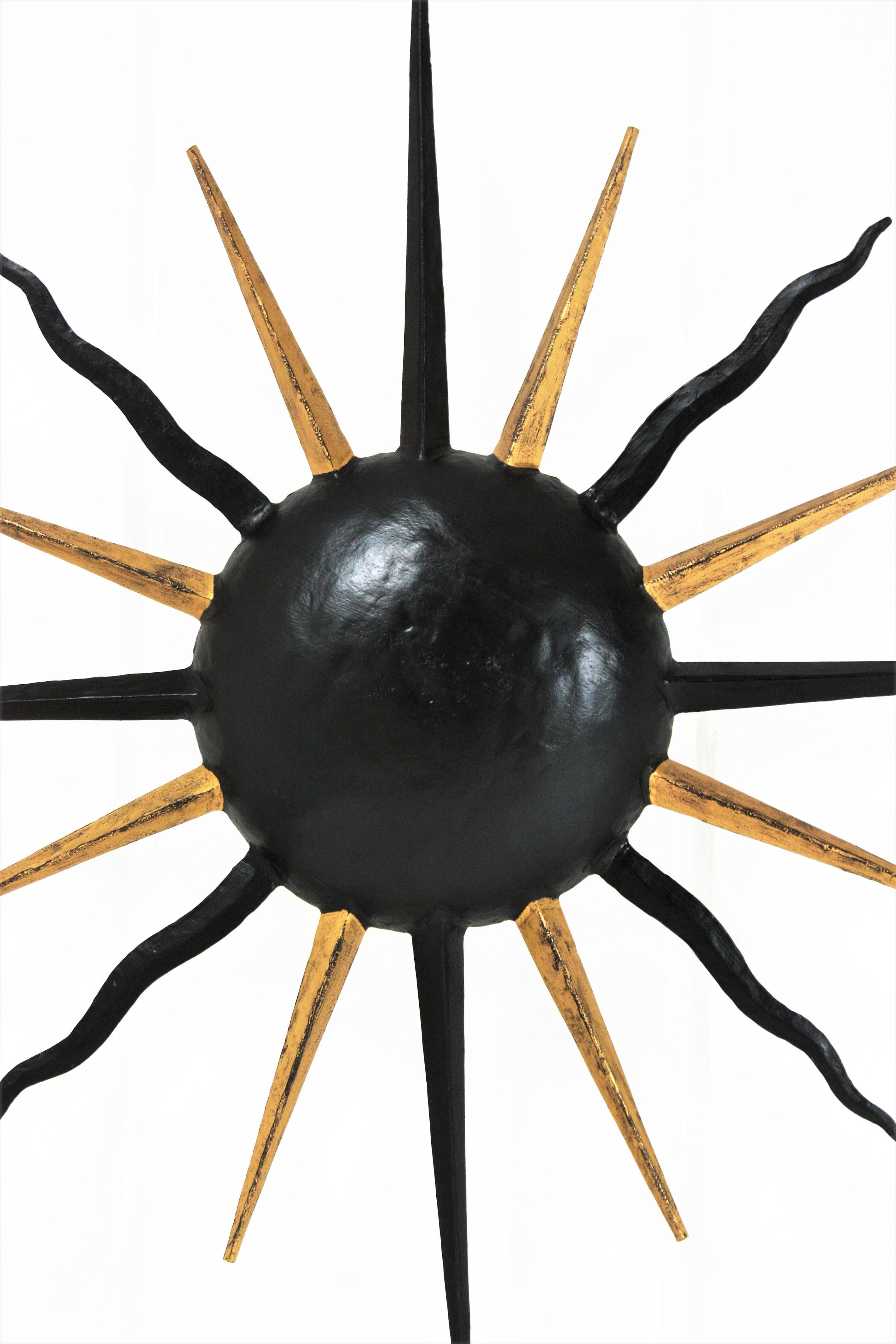 20th Century French Sunburst Light Fixture in Black and Gilt Iron, Gilbert Poillerat Style For Sale