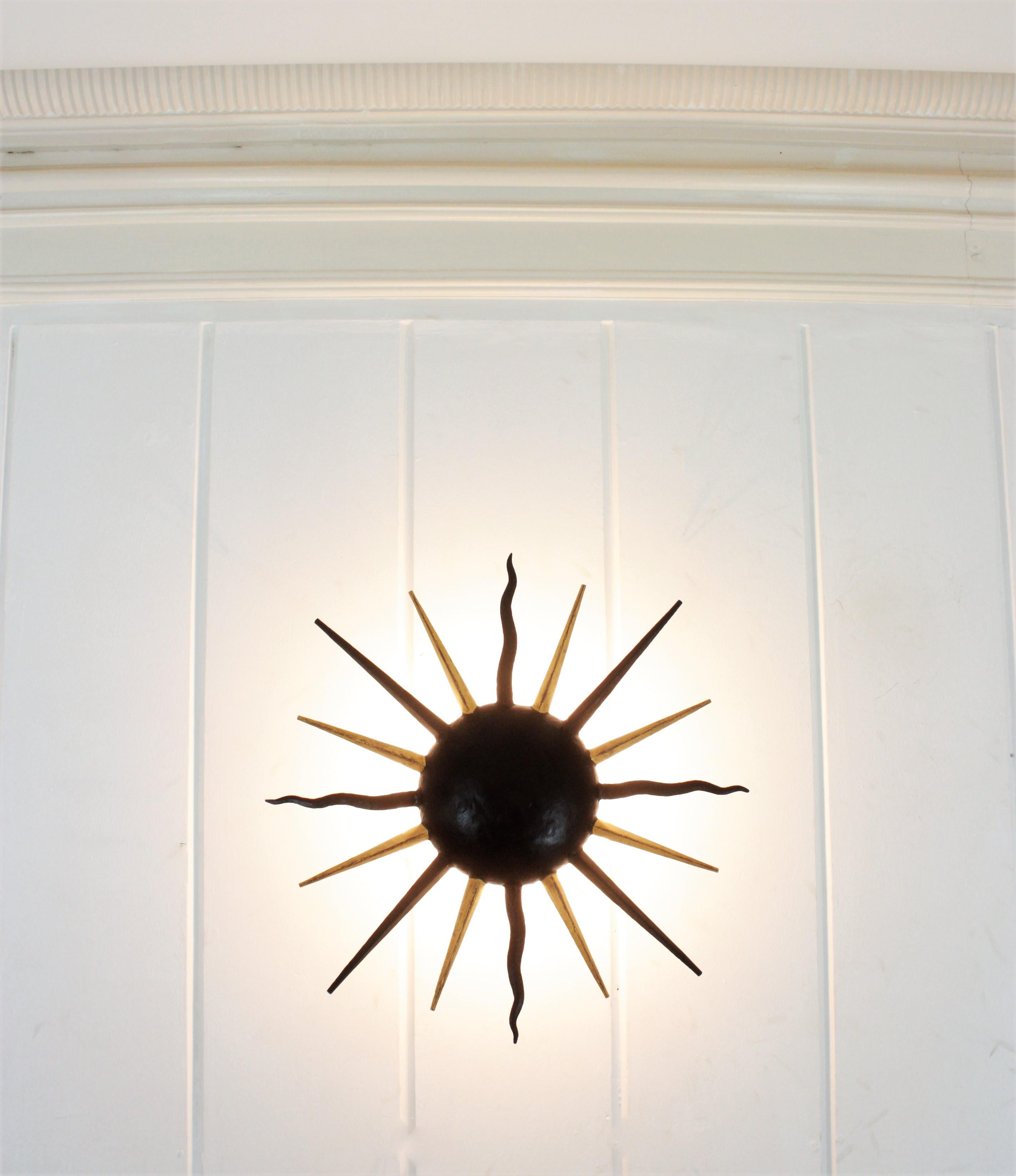 French Sunburst Light Fixture in Black and Gilt Iron, Gilbert Poillerat Style For Sale 2