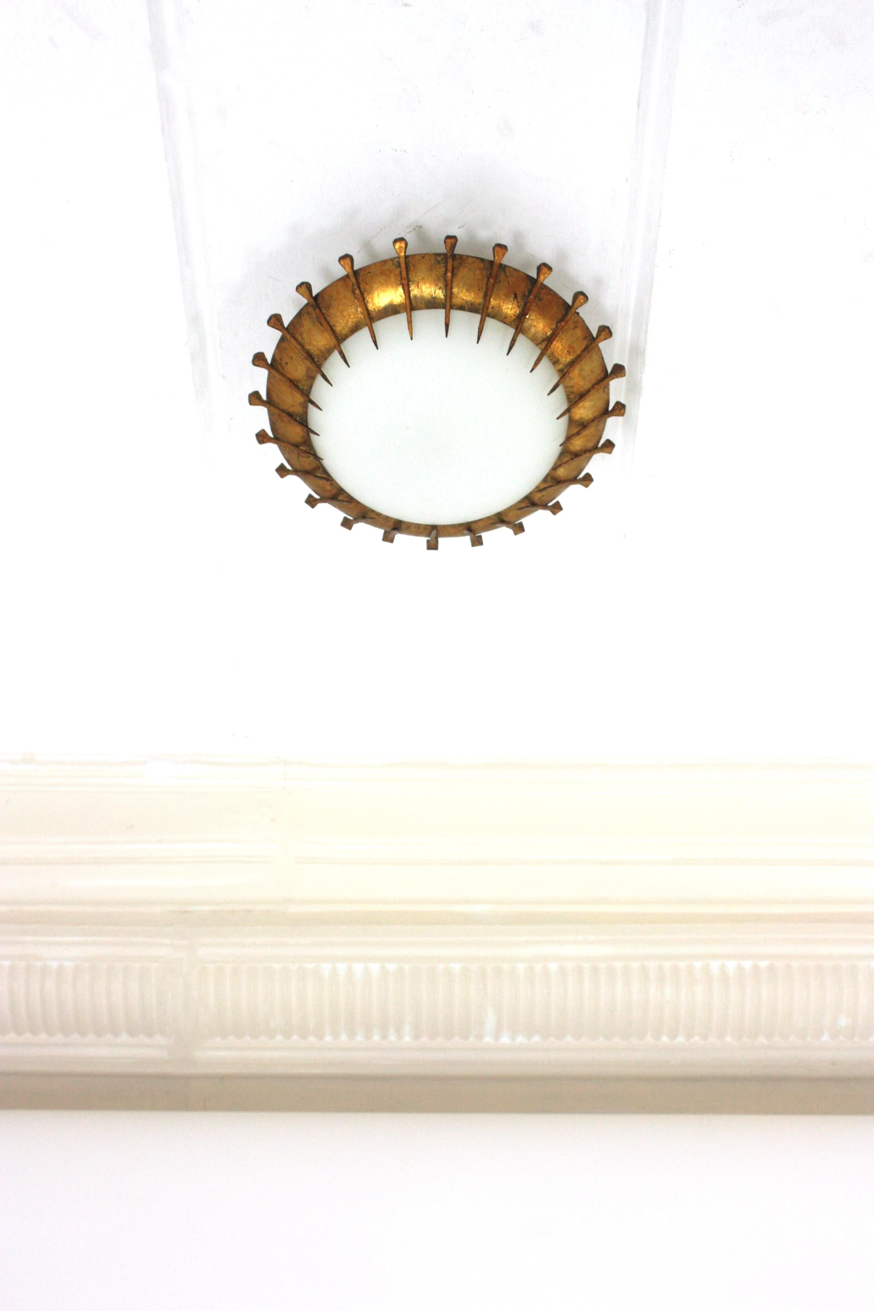 French Sunburst Light Fixture with Nail Design, Gilt Iron and Milk Glass  In Good Condition For Sale In Barcelona, ES