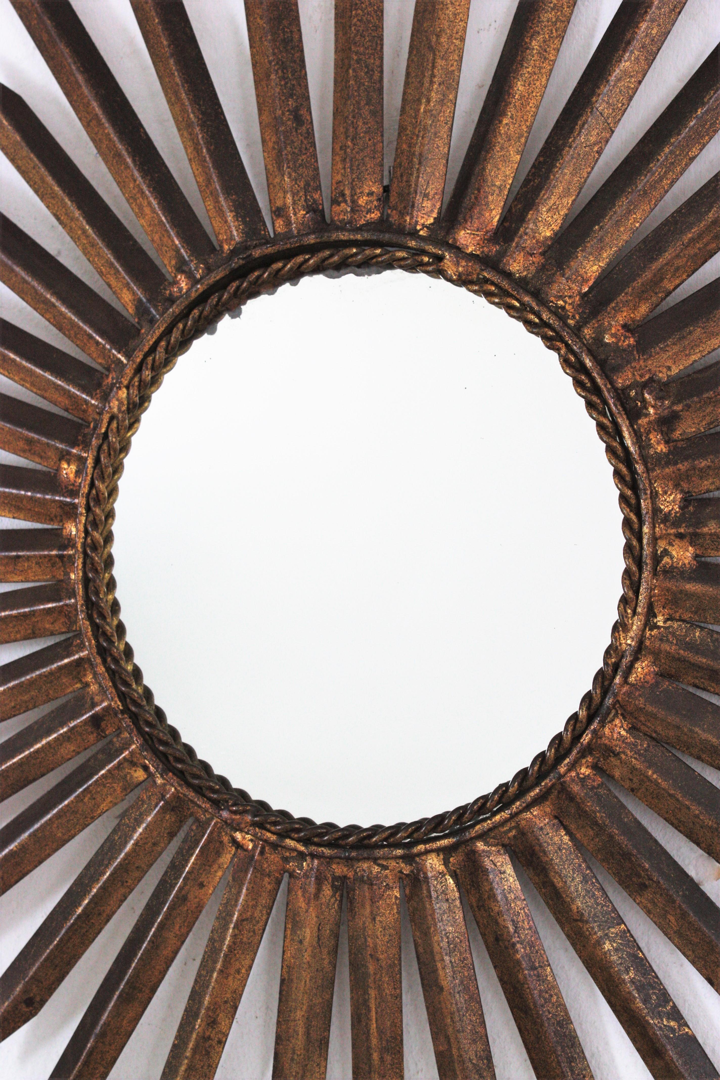 Hammered French Sunburst Starburst Mirror in Gilt Iron, Gilbert Poillerat Style For Sale