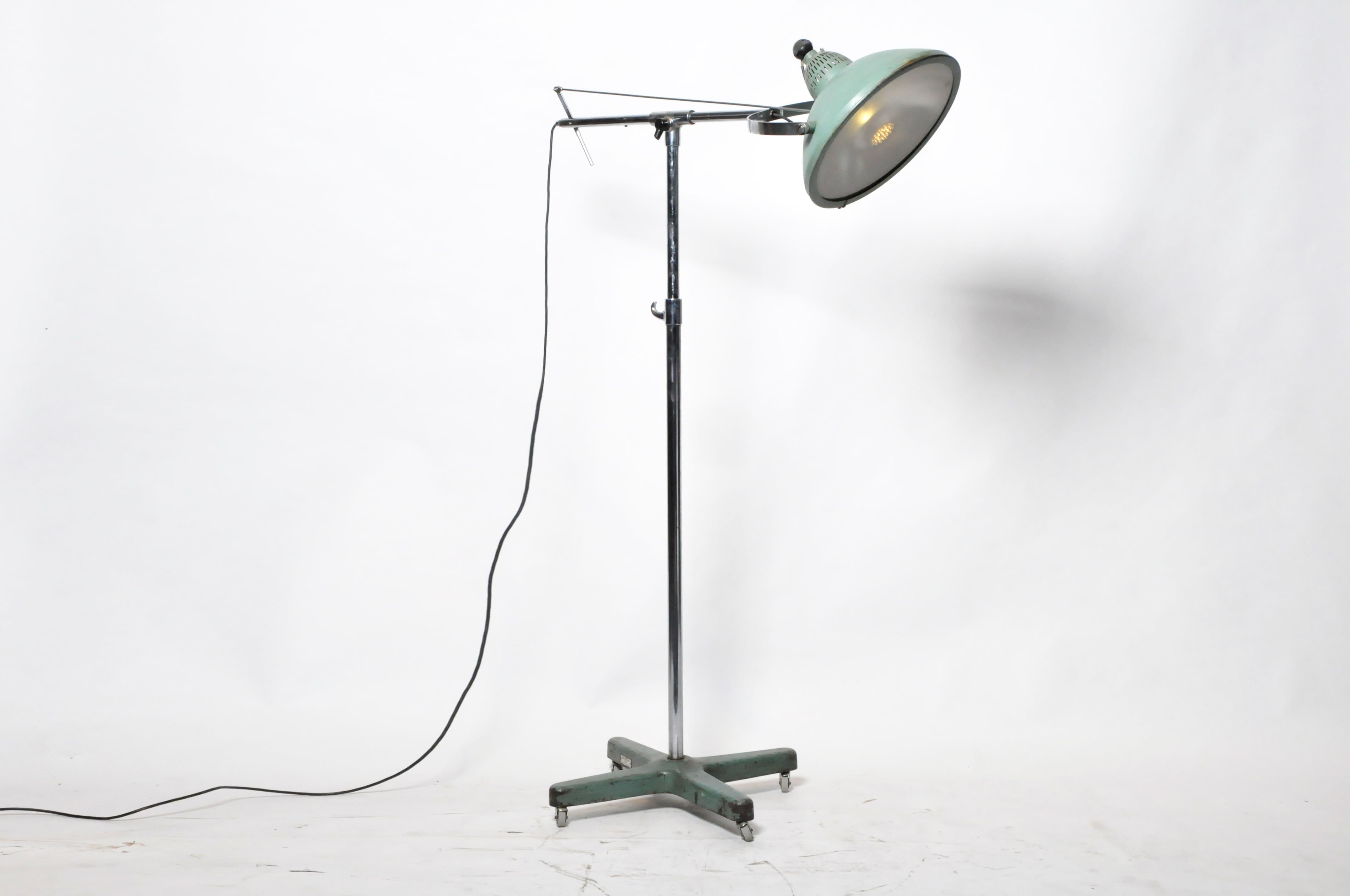 This exceptionally heavy and sturdy lamp was considered advanced technology in the 1940s. The lens is particularly interesting as it both concentrates and diffuses the light emitted through a pattern of alternating clear oculi set against a frosted
