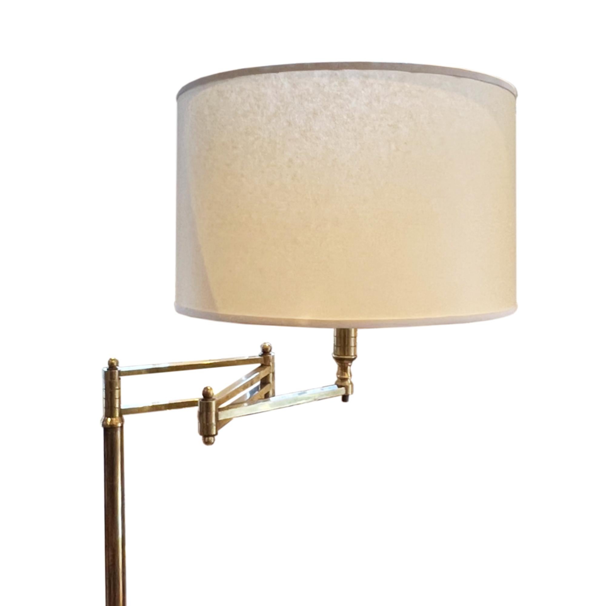 This floor lamp was made in France in the 1960s and is fully adjustable, please take a look at all our pictures.

A simple design, this light is made from brass with a solid white marble base. This ensures it remains sturdy, even with the arm fully