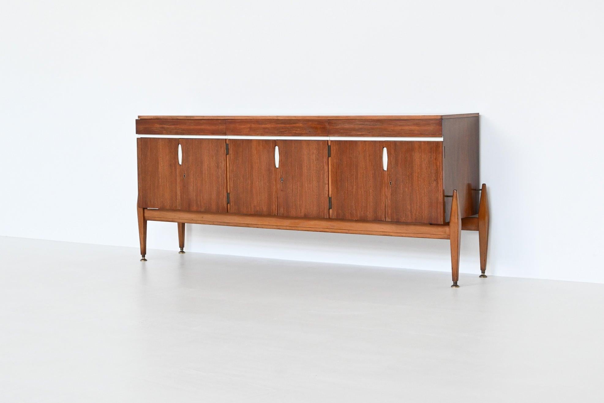 Beautiful shaped unusual sideboard by unknown designer or manufacturer, France 1960. This very nice symmetric sideboard is made of beautiful grained walnut wood. The cabinet is supported by a solid walnut wooden frame with tapered legs and brass
