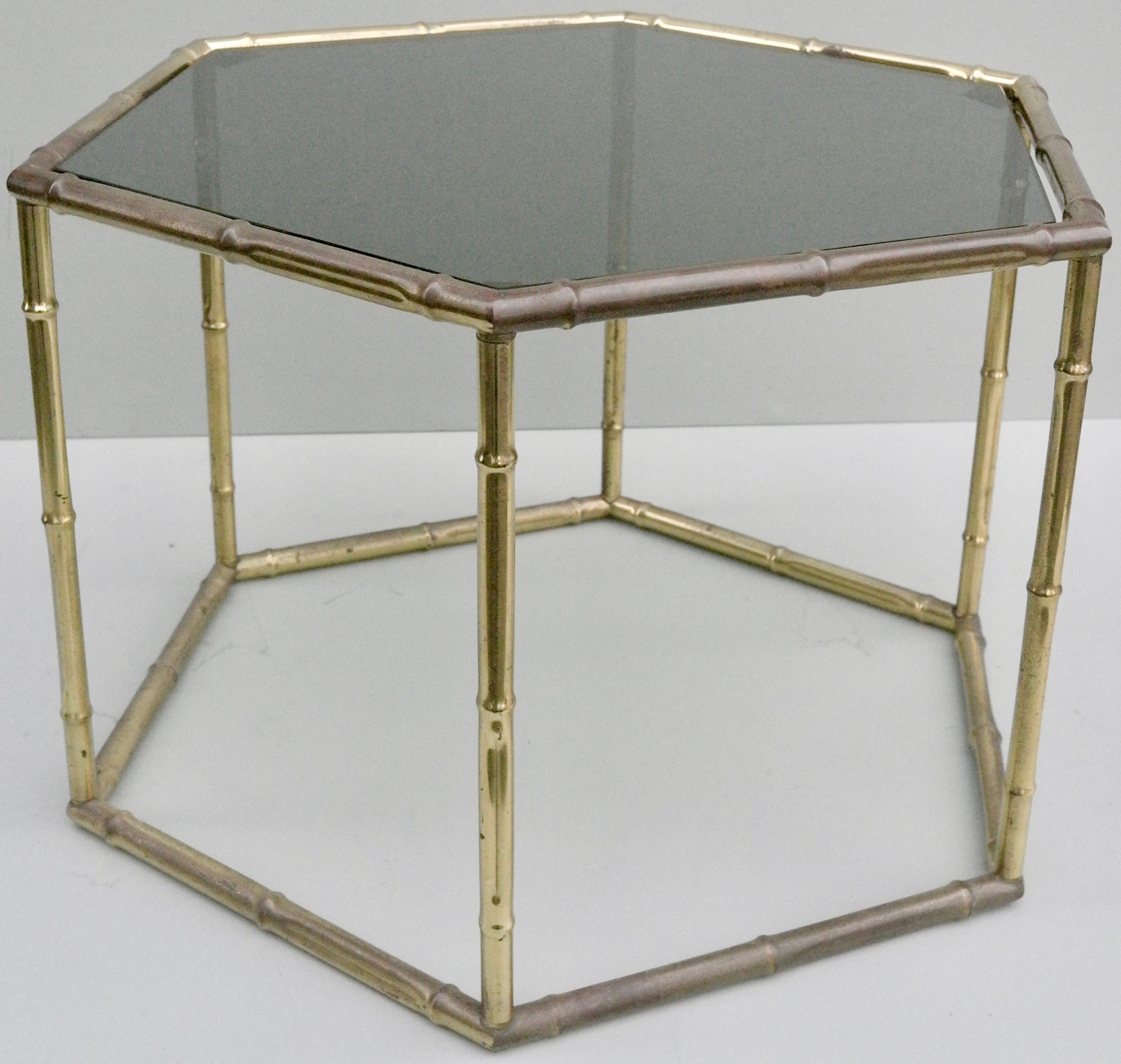 French symmetrical gold metal bamboo side table with dark glass top.