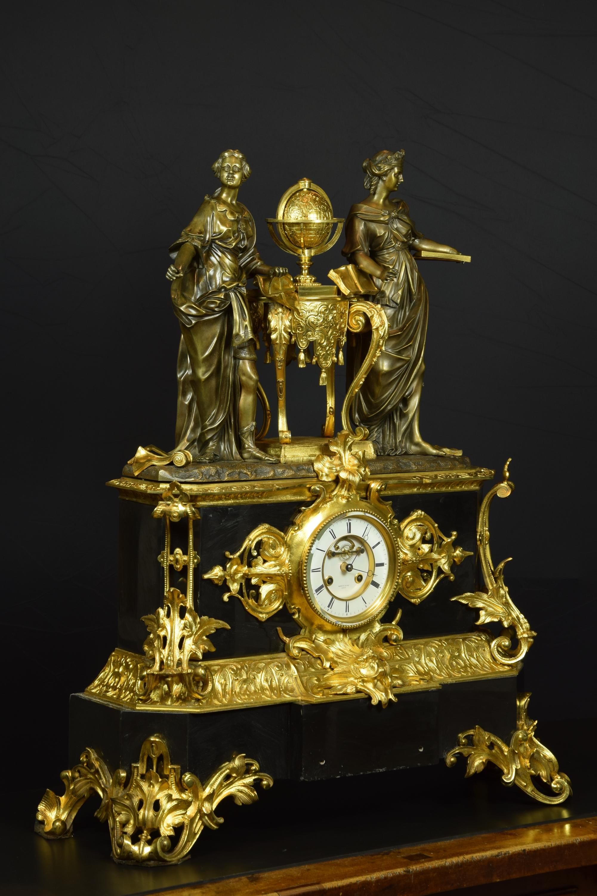French table clock with allegory of sciences, 19th century. Belgian marble and gilded bronze.
The white dial with numeration in Romans presents breguet needles and part of the movement in sight. It is housed inside a protective glass, decorated with