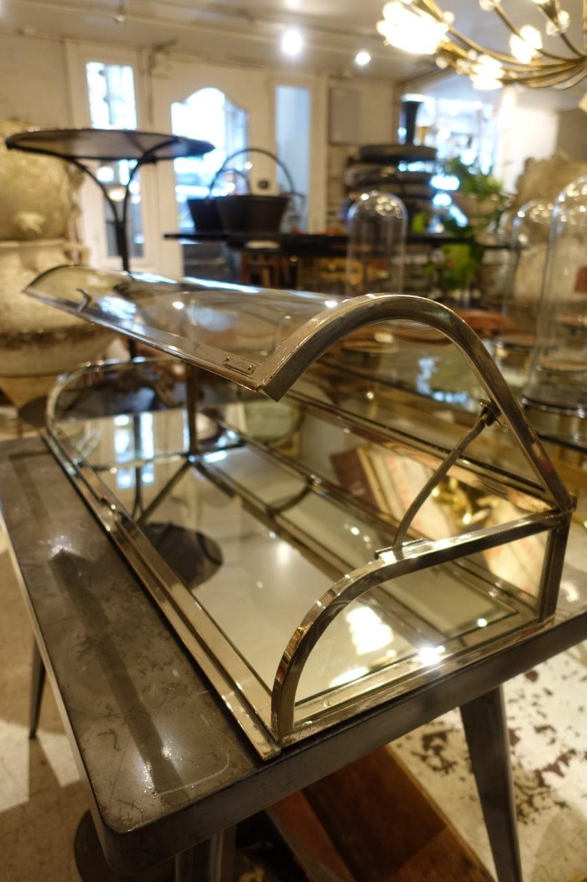 Wonderful practical and elegant vintage chrome framed and glass counter display unit, from 1920s-1930s France. The mirrored base makes for super reflections of your items, and the bowed glass lid is stunning. It can also remain open when