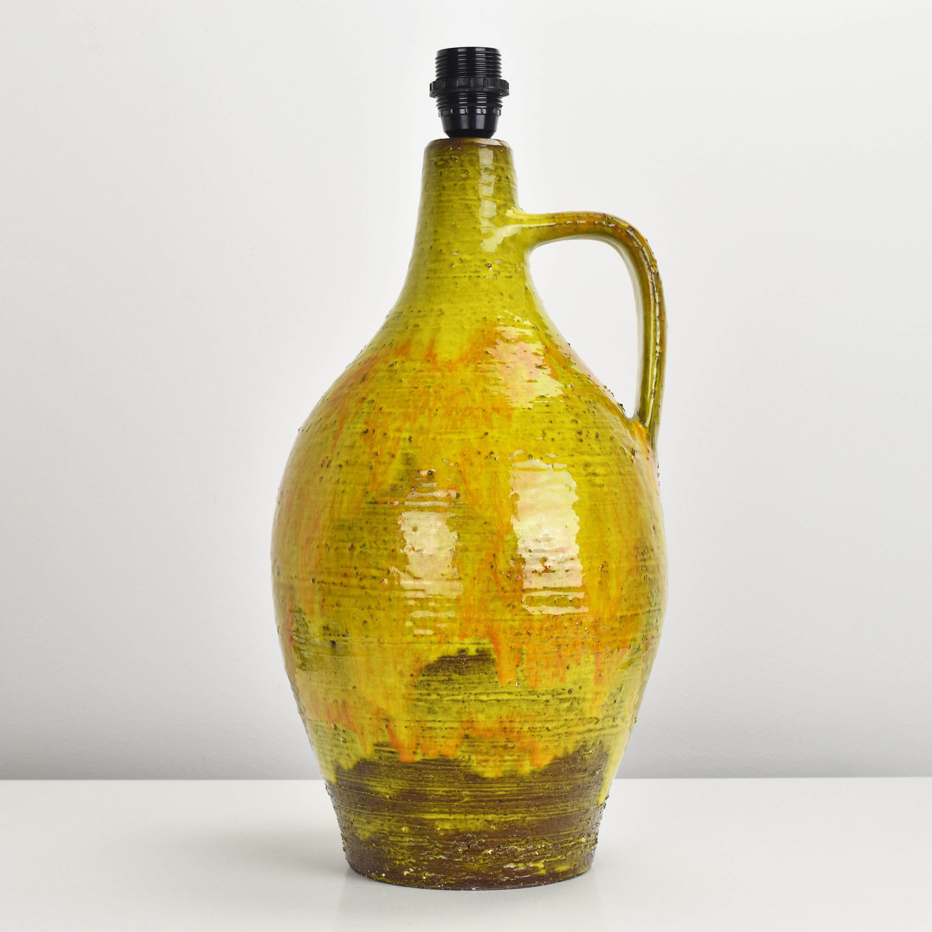Lovely drip glazed single handle floor or table lamp base with a vibrant yellow glossy glaze over a dark brown stoneware in the manner of Bitossi.

Height ceramic only.