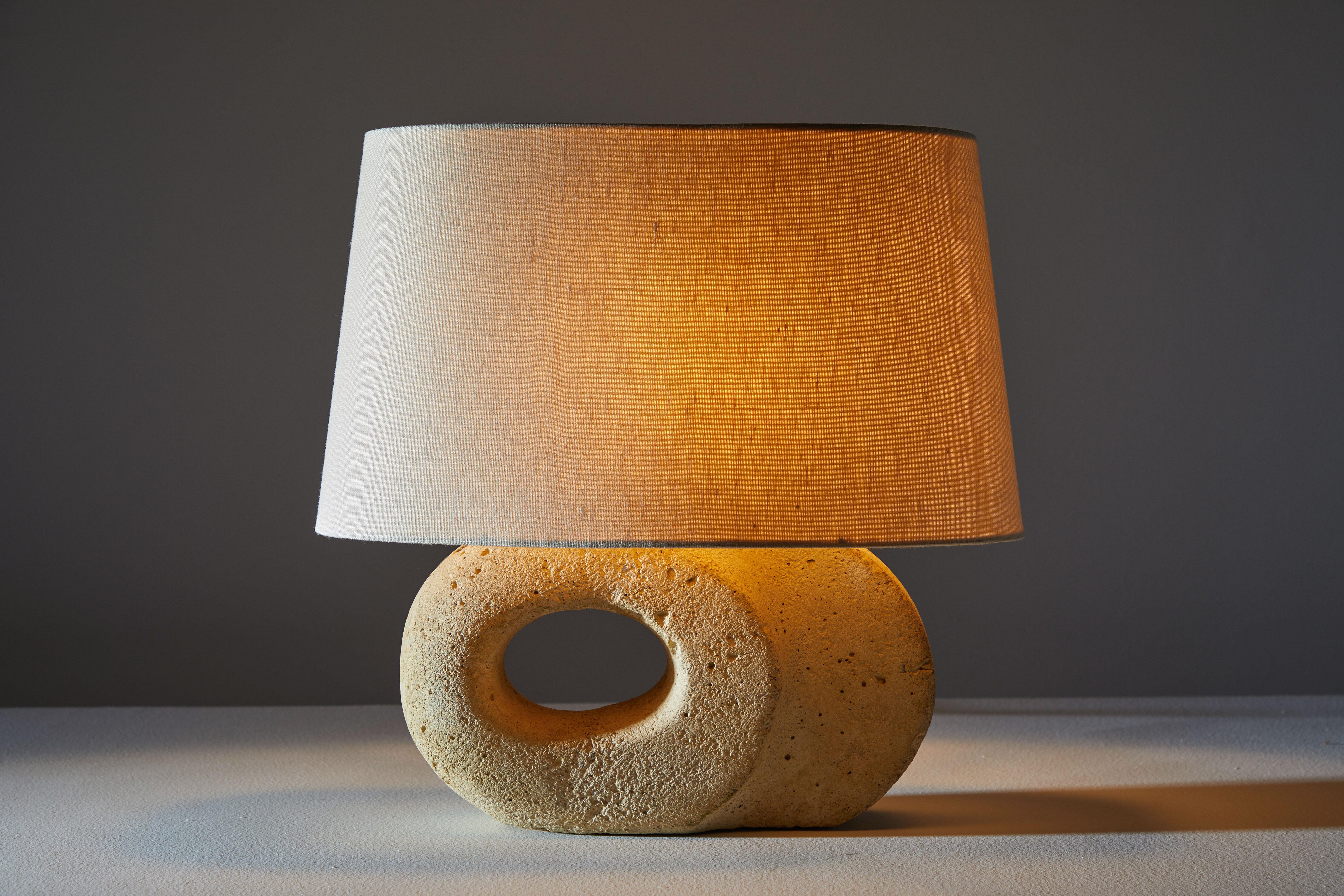 Table lamp. Manufactured in France, circa 1970s. Carved stone with custom linen shade. Original cord with hand on/off switch. Height displayed includes shade. Height of fixture is 9