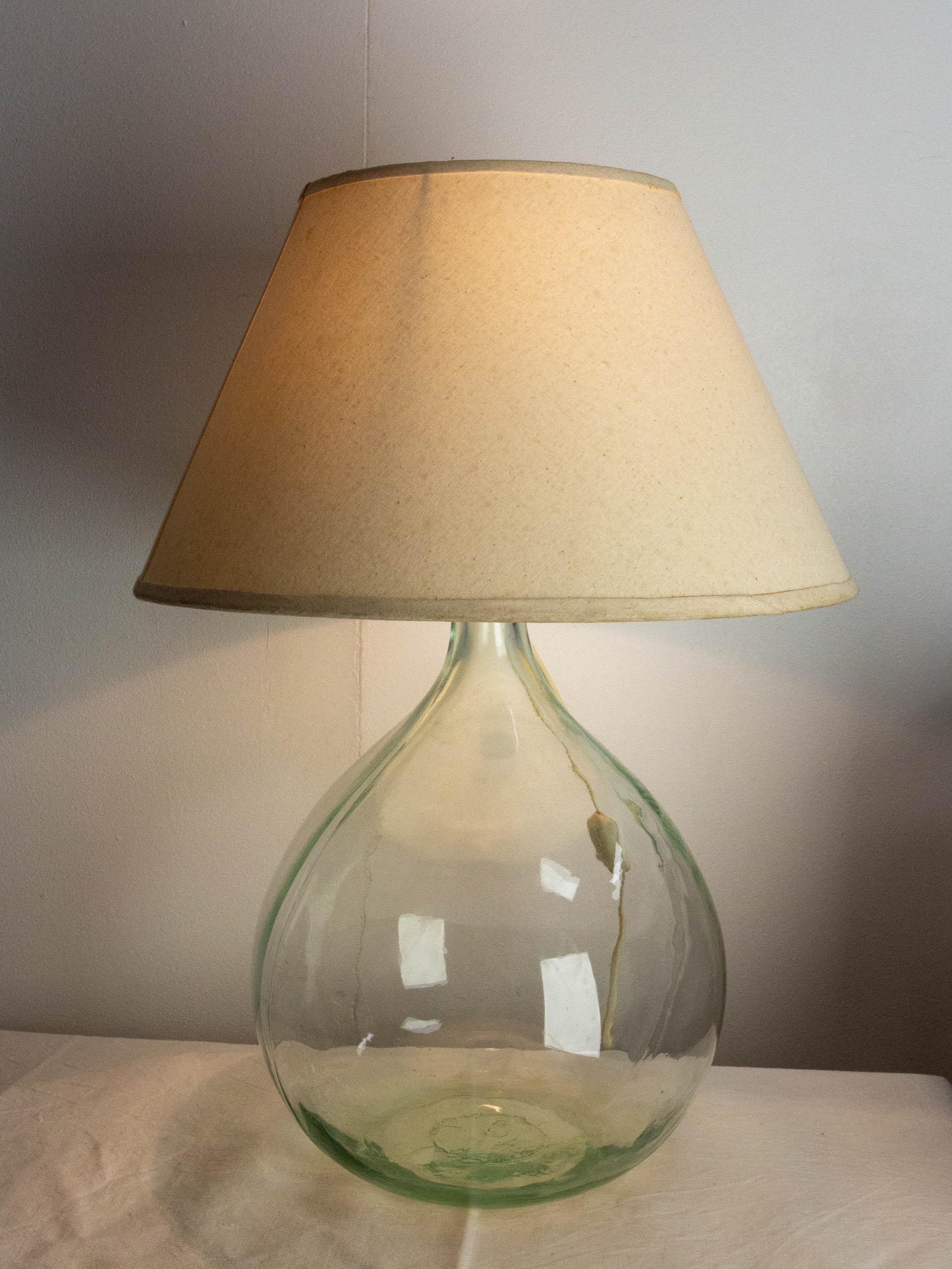 Table lamp mounted on a dame Jeanne or carboy vintage glass bottle demijohn
The lamp was mounted on the lady jane circa 1960.
Irregularities in the glass that give it all its charm.
Height given without the bulb.
Lampshade not included

2.64 US