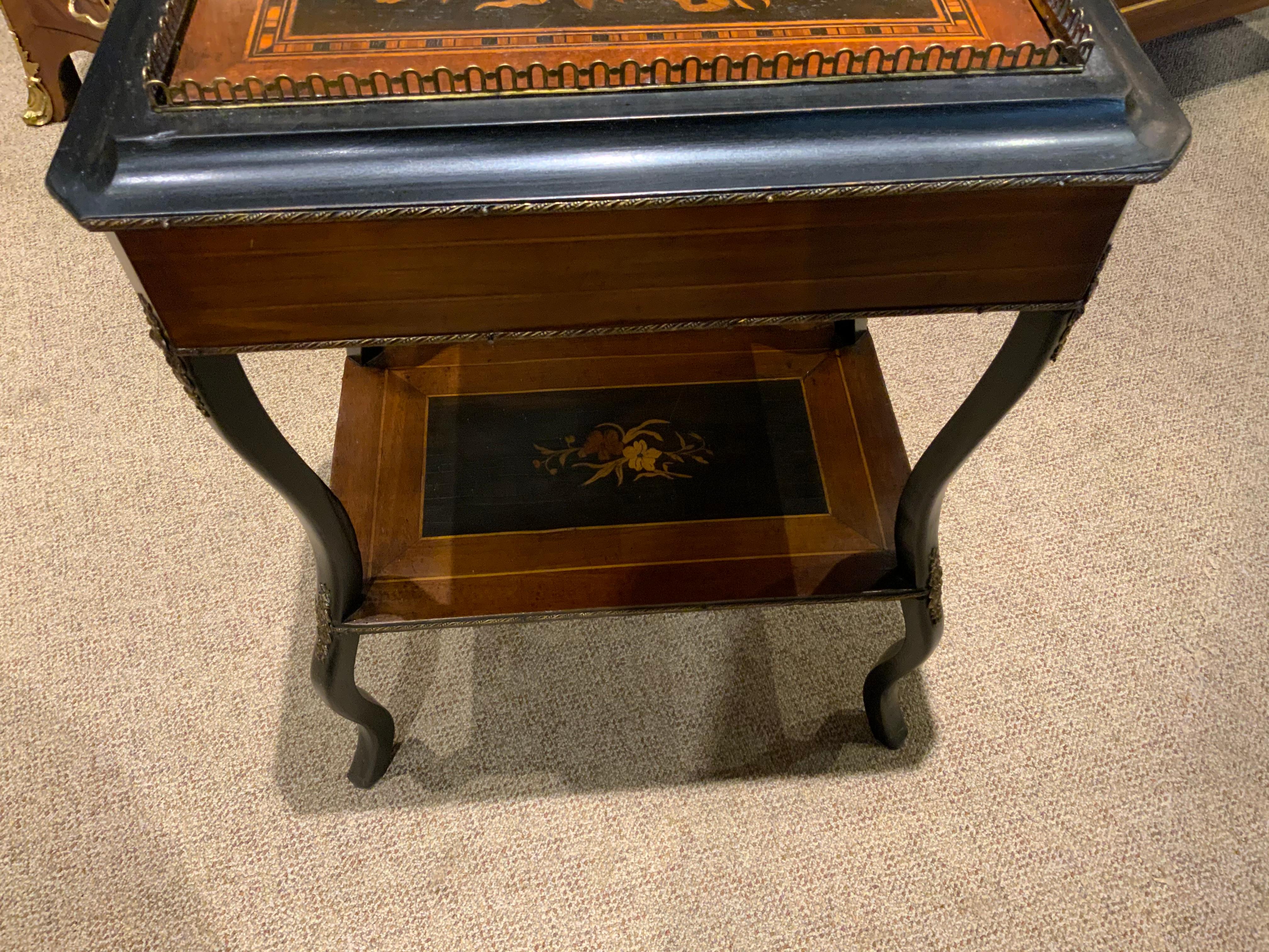 French occasional table made of rosewood and various other woods forming a beautiful 
Marquetry floral pattern in the center top with a bronze gallery encircling the top edge.