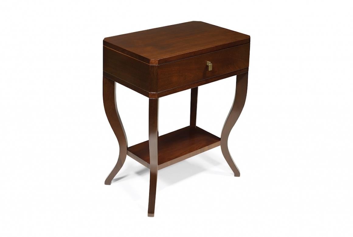 Talbot is a contemporary bedside table with curved legs, shown in walnut with a dark walnut finish. It features one central drawer and a lower shelf.

· Handcrafted in cherry wood, oak, mahogany or painted.

· Hand painted in an extensive range
