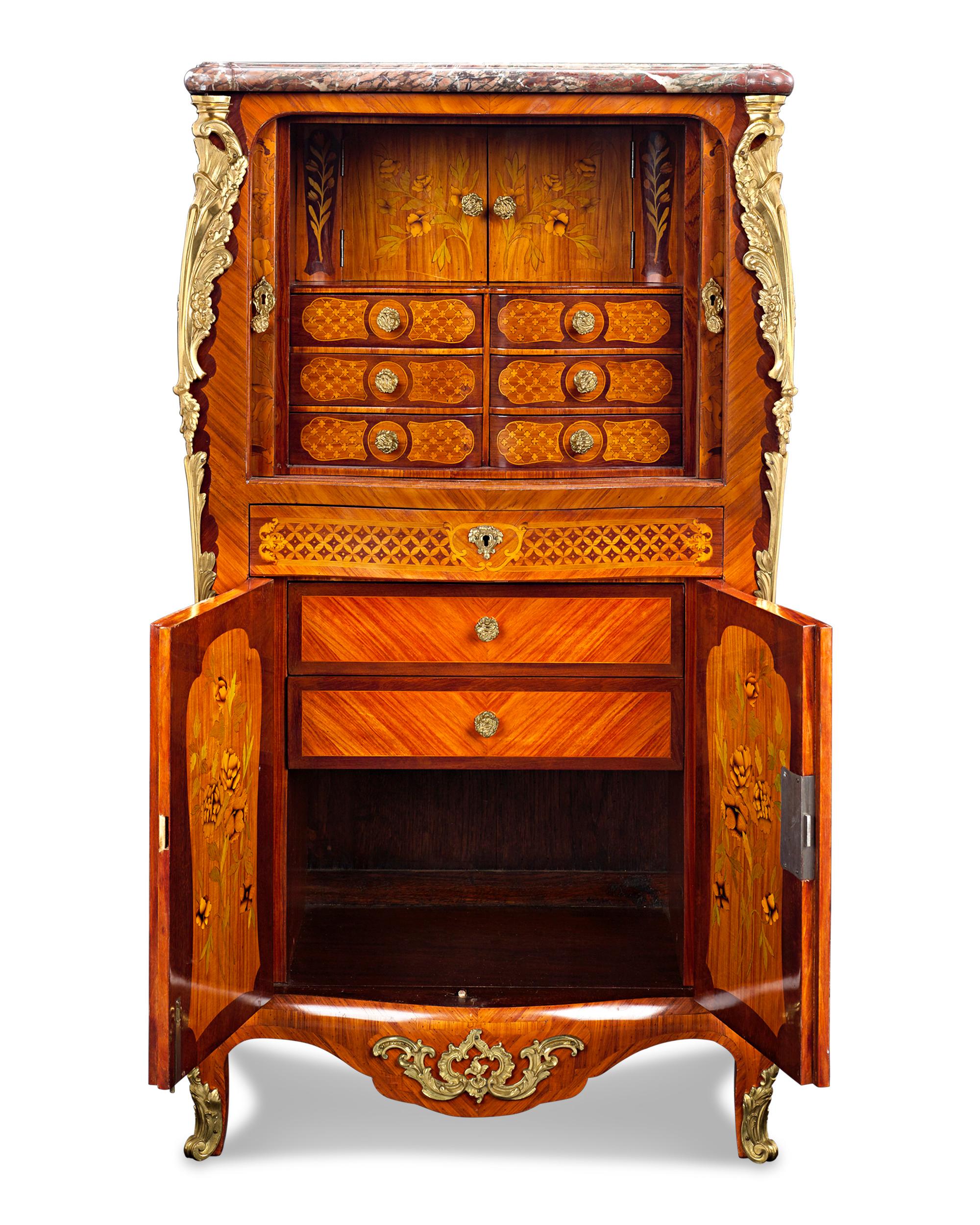 With its romantic flourishes and curves, this 19th century French secretaire illustrates the very best elements of Louis XV-style furniture. Meticulously crafted, the writing cabinet immediately presents itself as a work of art, enveloped in floral