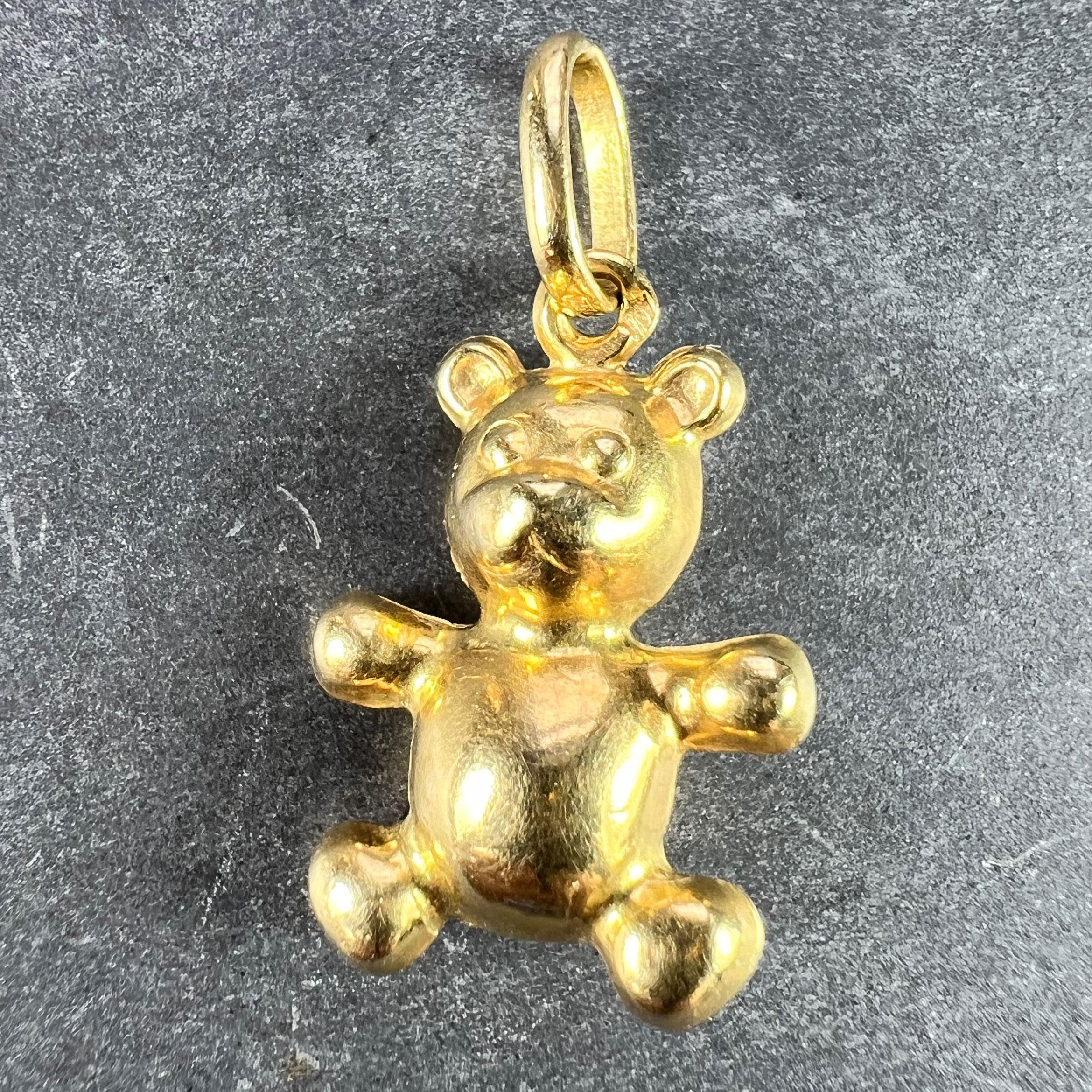 A French 18 karat (18K) yellow gold charm pendant designed as a 3-dimensional teddy bear. Stamped with the eagle's head for French manufacture and 18 karat gold.

Dimensions: 1.8 x 1.5 x 0.25 cm (not including jump ring)
Weight: 1.39 grams
(Chain