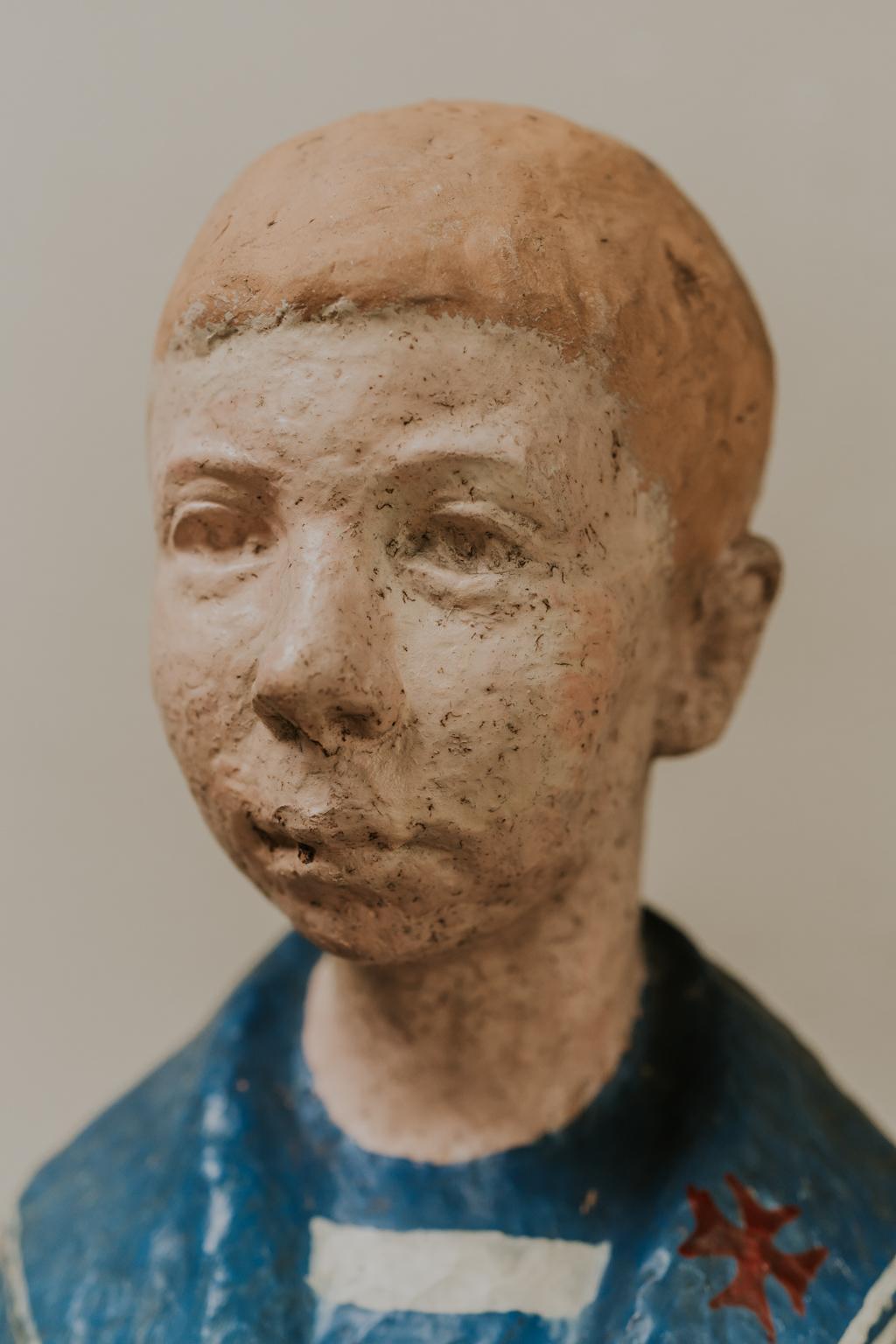 Naive terra cotta buste of a young boy 