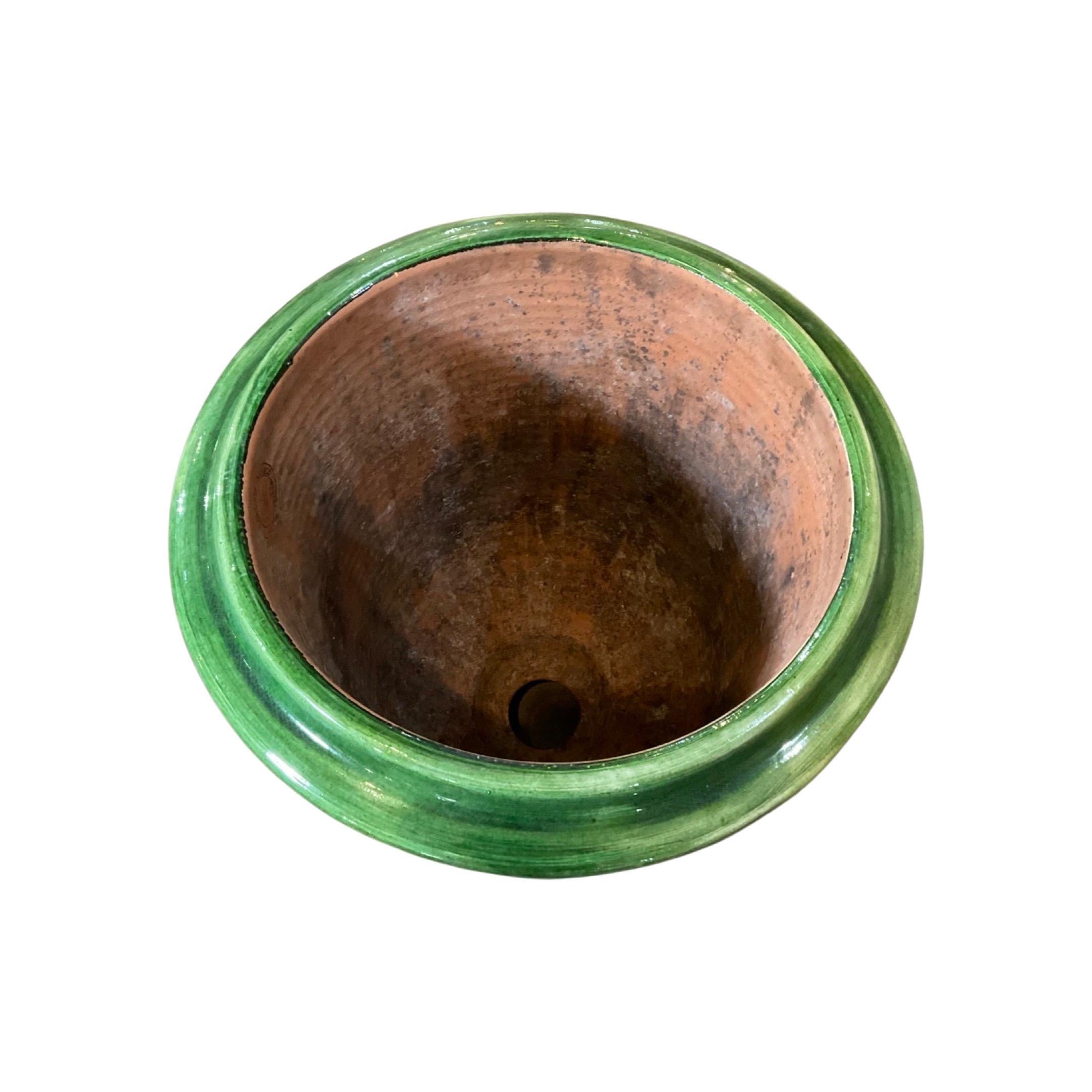 This terracotta French Anduze Planter, dating back to the 18th century, features beautiful green detailing and a timeless anduze design. A must-have for any gardening expert, this planter adds an air of refinement and historical significance to your