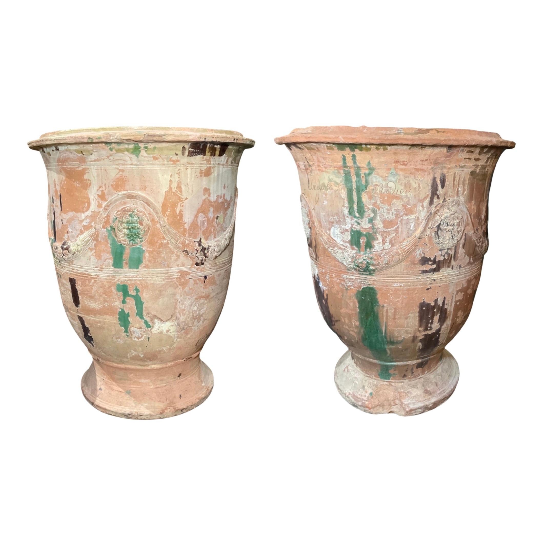 This 19th century pair of large size French-crafted Anduze planters boast a timeless aesthetic, constructed of strong terracotta with a delicate pattern. An ideal way to beautify your garden, these planters offer an elegant touch of classic charm.
