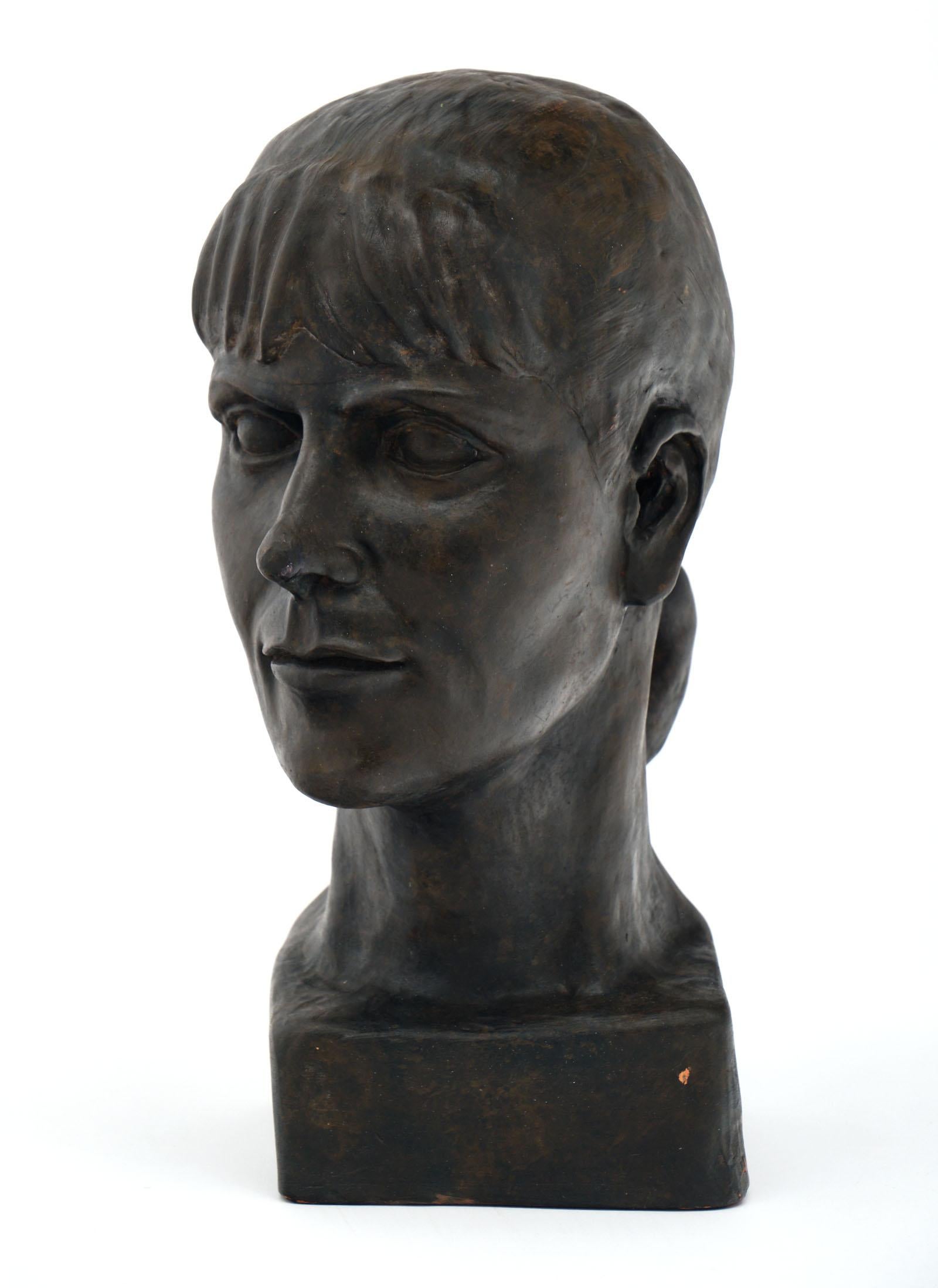 French terracotta bust of a woman. This piece is signed “DB 1990” and features a warm bronze color finish.