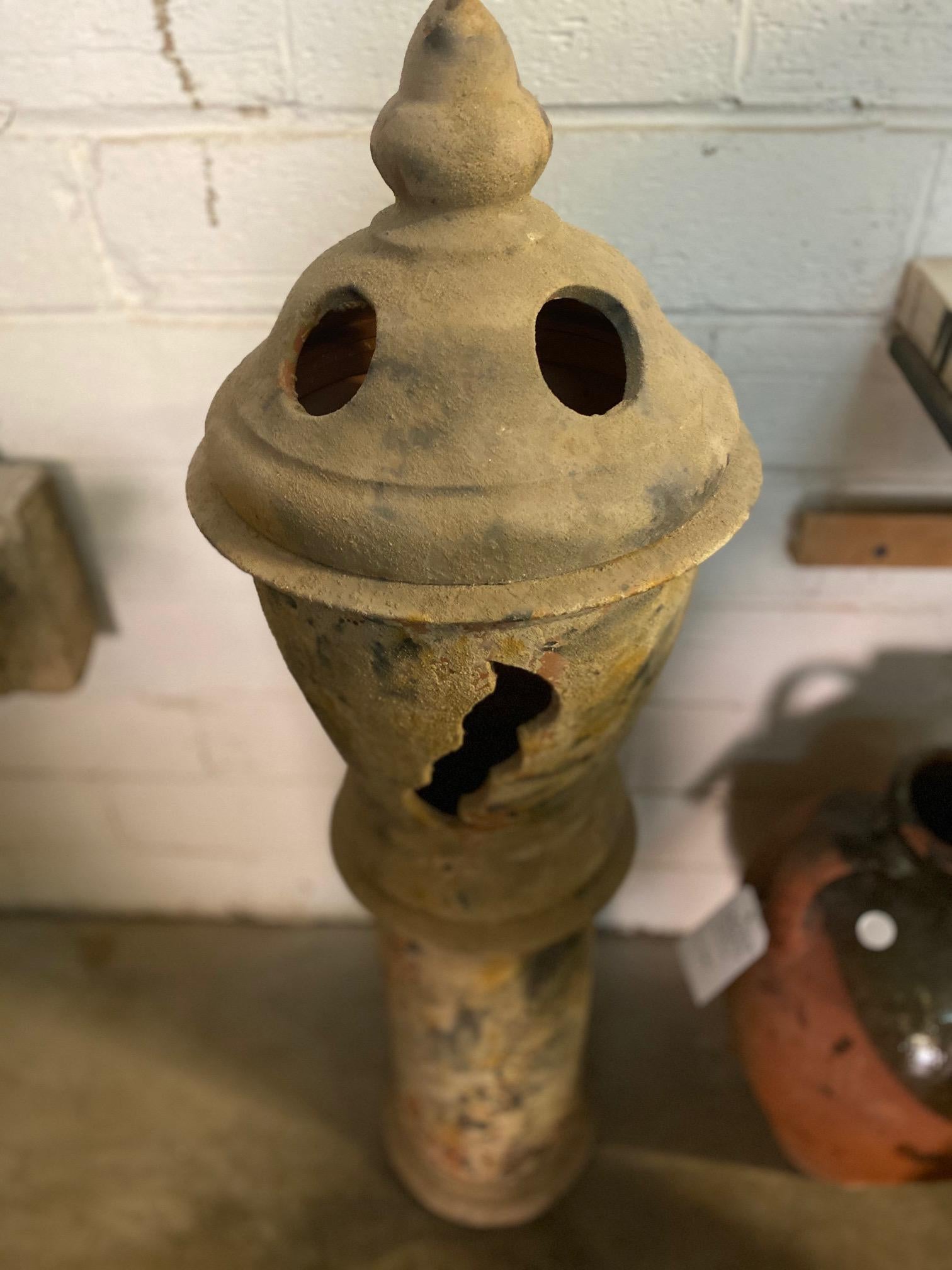 This terracotta chimney top originates from France and breaks down in to three parts for easy movement.

Measurements: 42.5” H x 14” D.